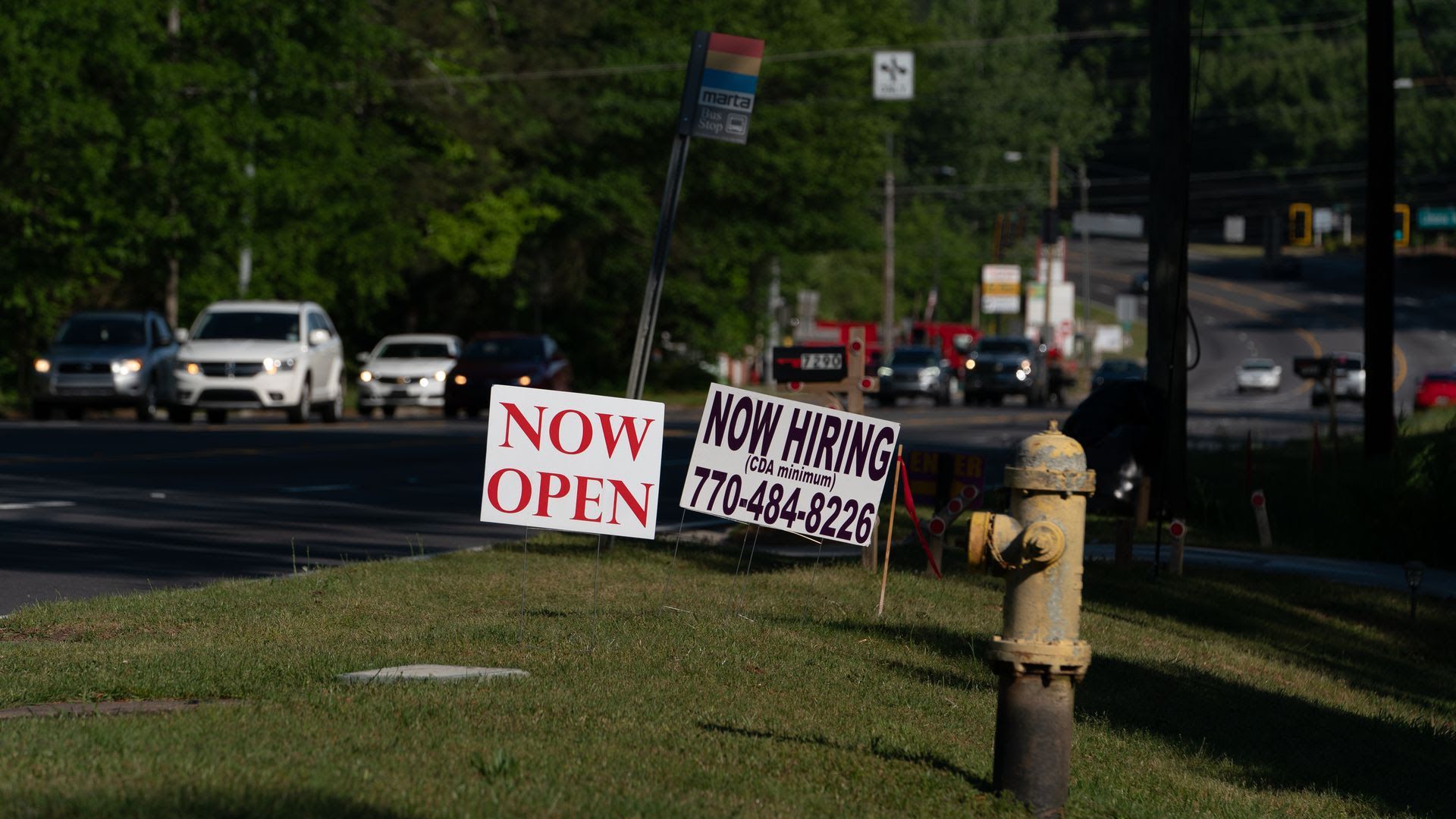 Hiring signs on a lawn at night