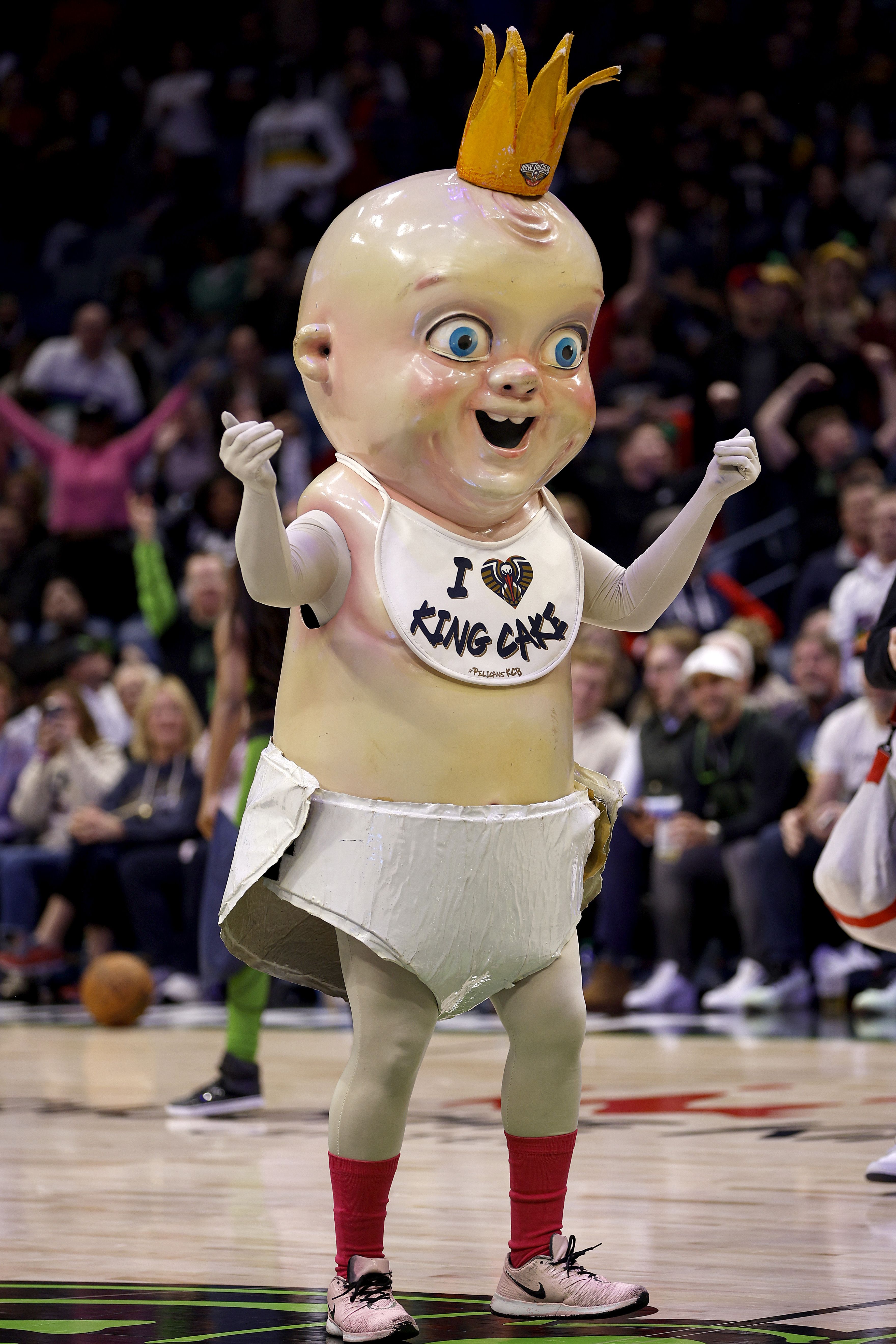 Photo shows King Cake Baby wearing red socks.