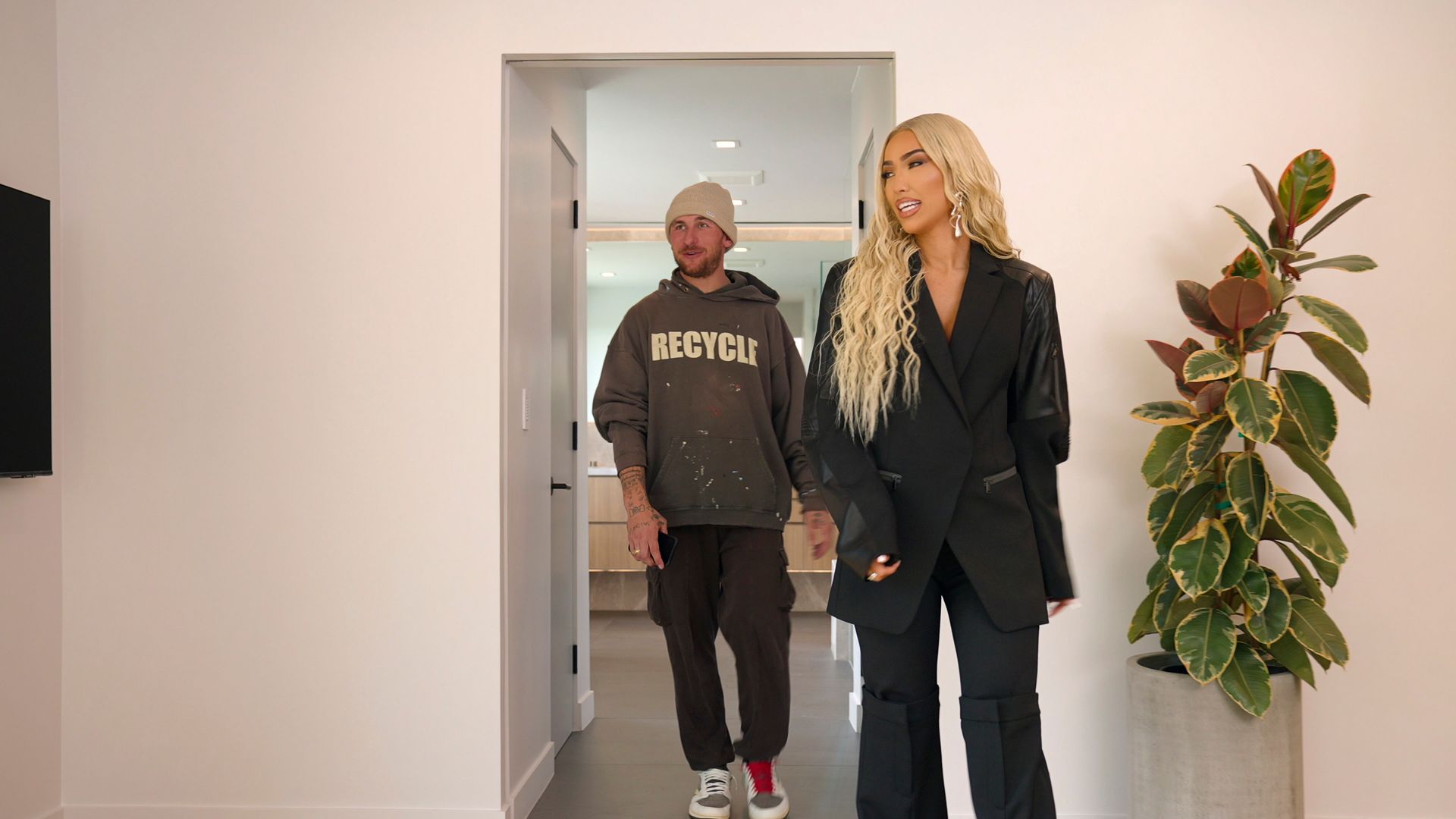 A man and a woman tour a house together