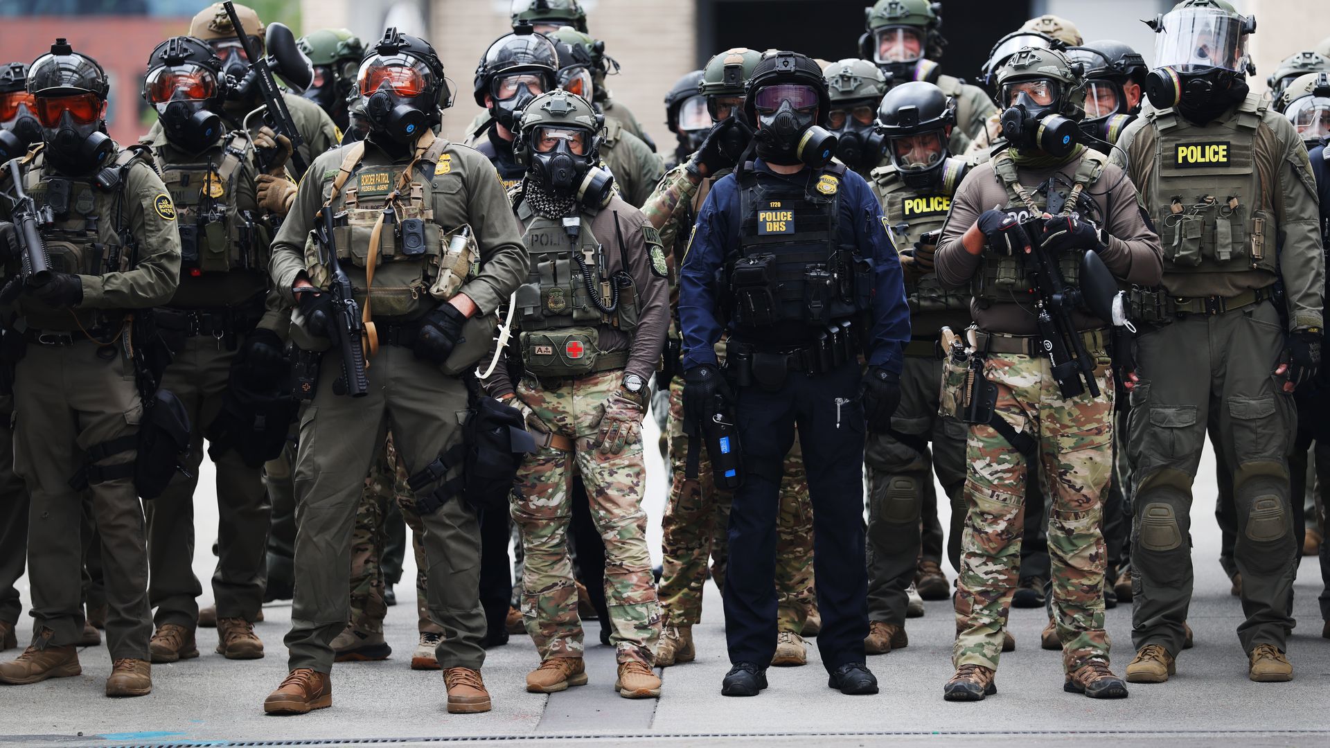 Federal agents outside a downtown U.S. Immigration and Customs Enforcement (ICE) facility in Portland, Ore.
