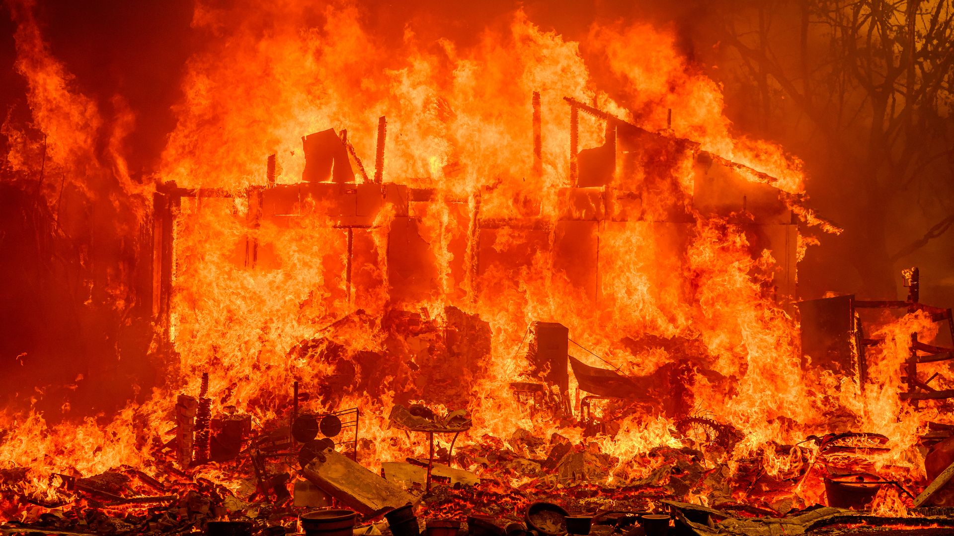A house burning at night in Oroville, California in July 2024.
