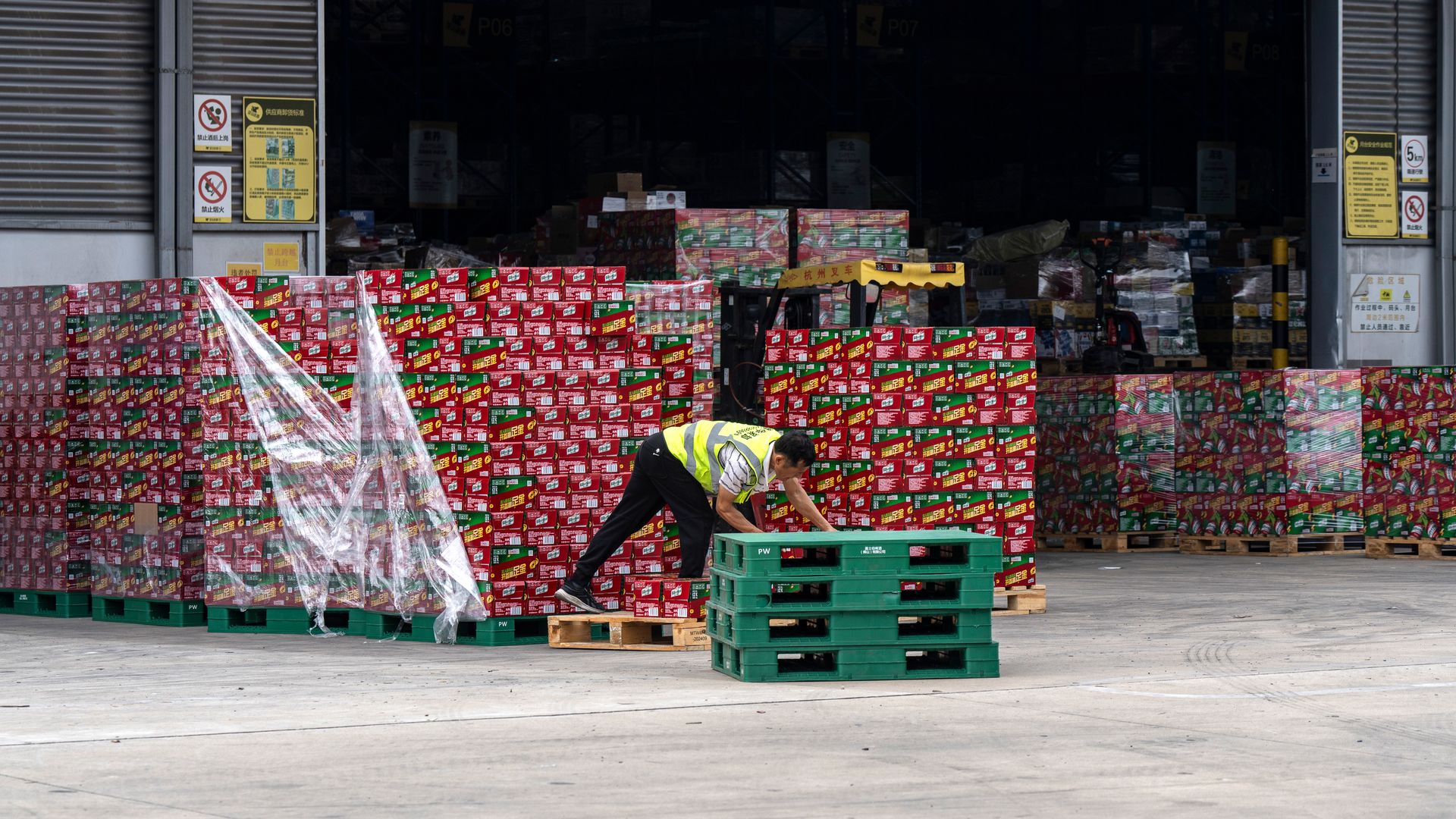 I person sorts through pallets of goods at a warehouse