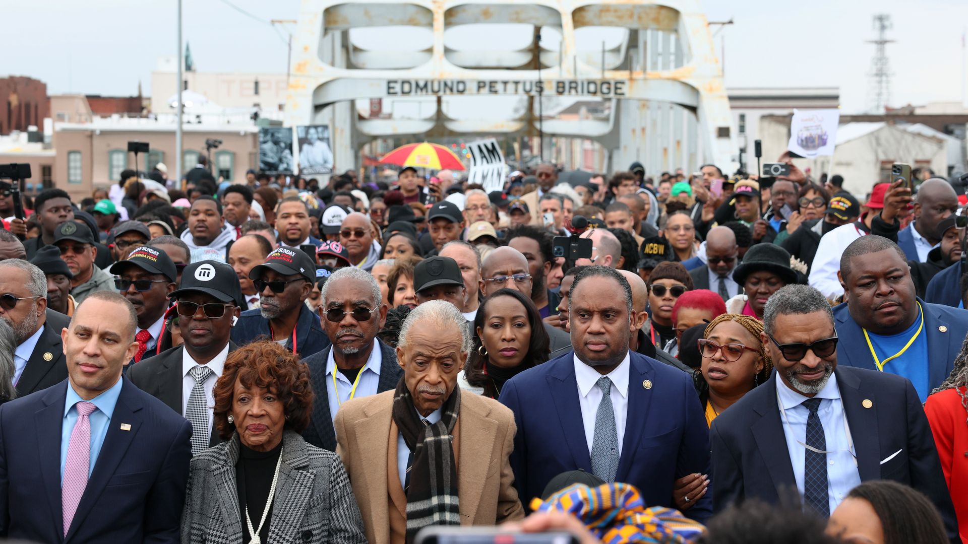 House Minority Leader Hakeem Jeffries (D-NY), Rep. Maxine Waters (D-CA), Rev. Al Sharpton, Rep. Jonathan Jackson (D-IL) walk across Edmund Pettus Bridge as they commemorate the 60th anniversary of "Bloody Sunday" on March 9 in Selma, Alabama.