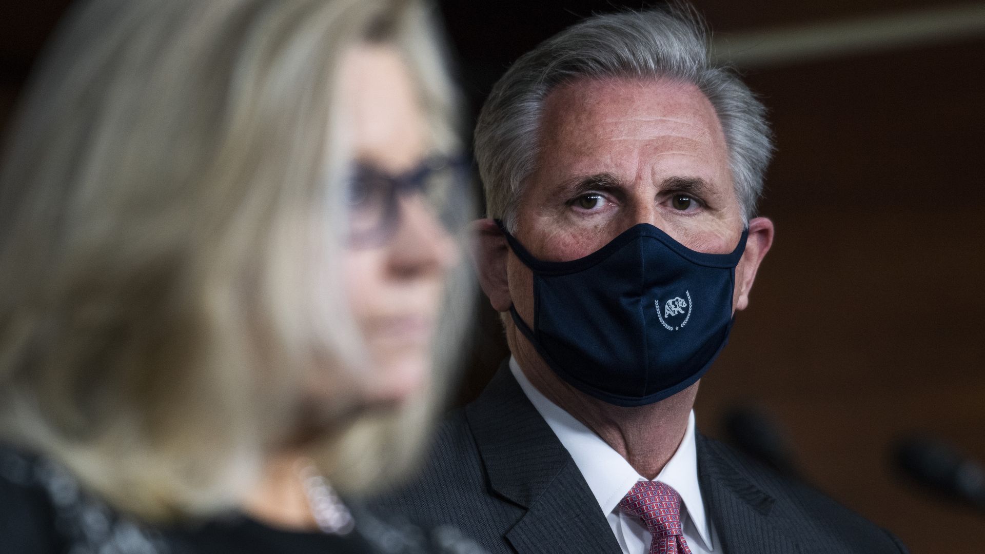 Rep. Liz Cheney is seen speaking as House Minority Leader Kevin McCarthy looks on.