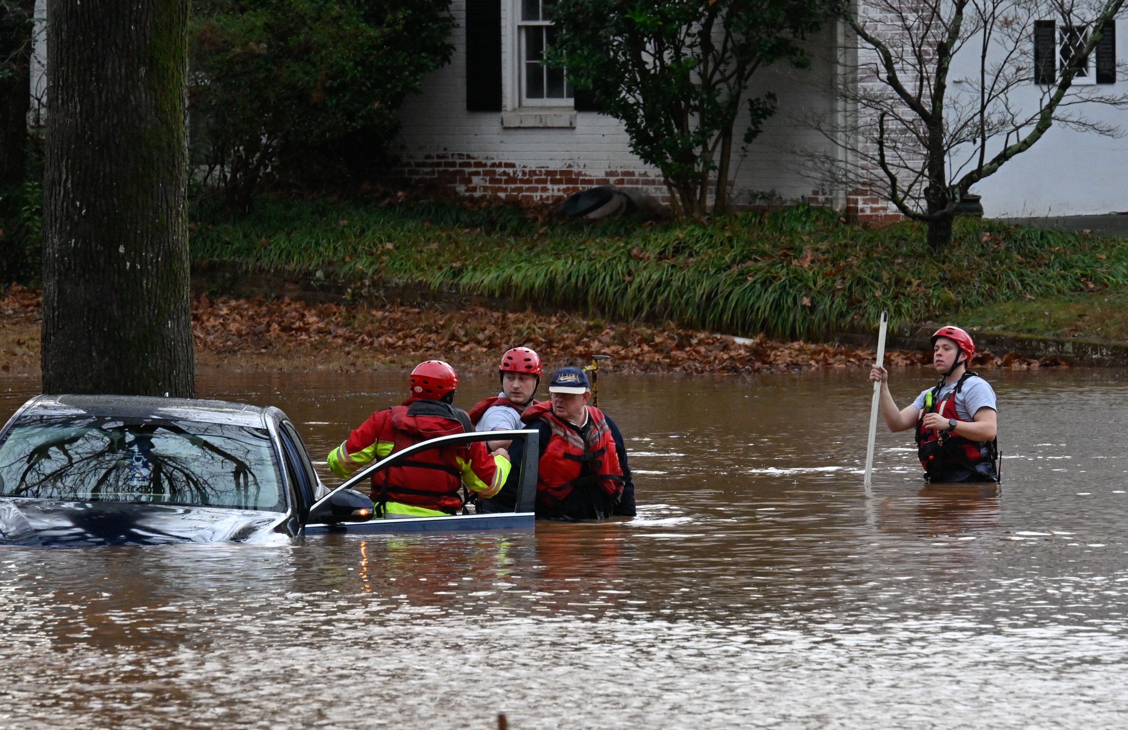 Firefighters rescue a man in car stuck in the flooded area as strong storms move through the southeast and the Carolinas producing flooding, powerful winds and tornadoes in Charlotte, NC, United States on January 09, 2024.