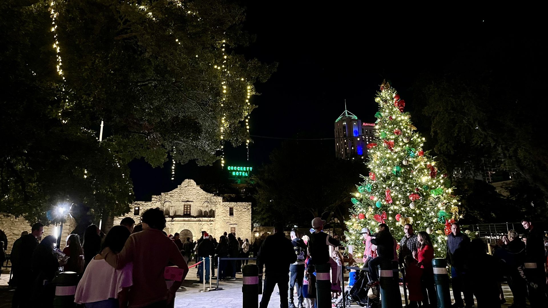 A view of the Alamo at night, with a Christmas tree. 
