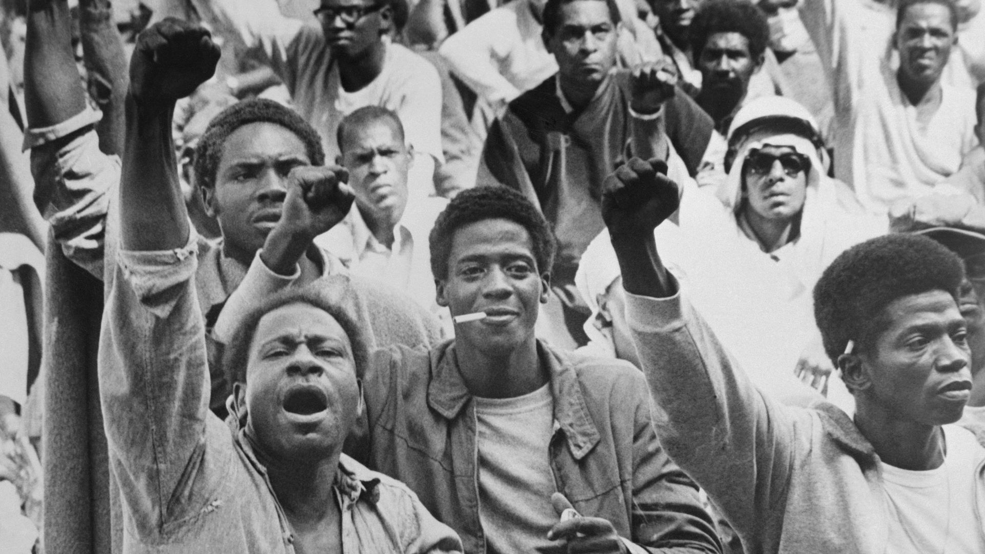 Black inmates at the Attica Correctional Facility give the black power salute while Commissioner R.G. Oswald negotiates with leaders of the takeover in 1971.