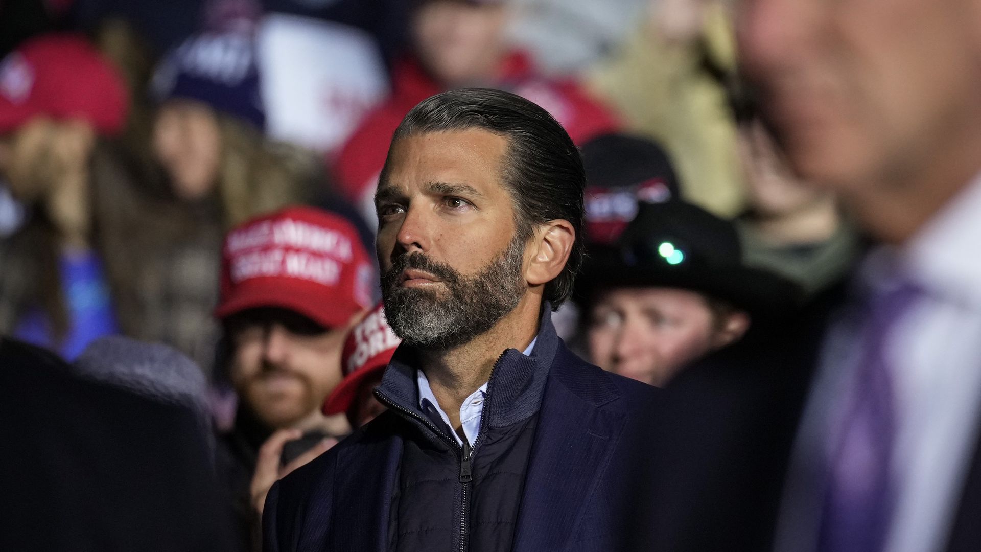 Donald Trump Jr. listens as former President Donald Trump campaigns for Sen. JD Vance on November 7, 2022 in Vandalia, Ohio. 