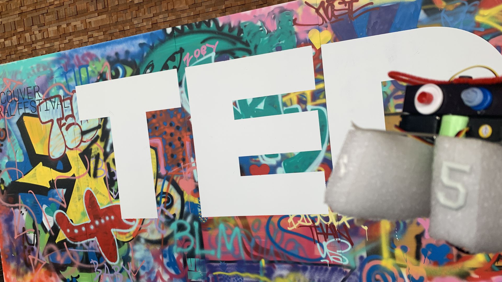 An image from TED 2019 with the TED logo and a robot