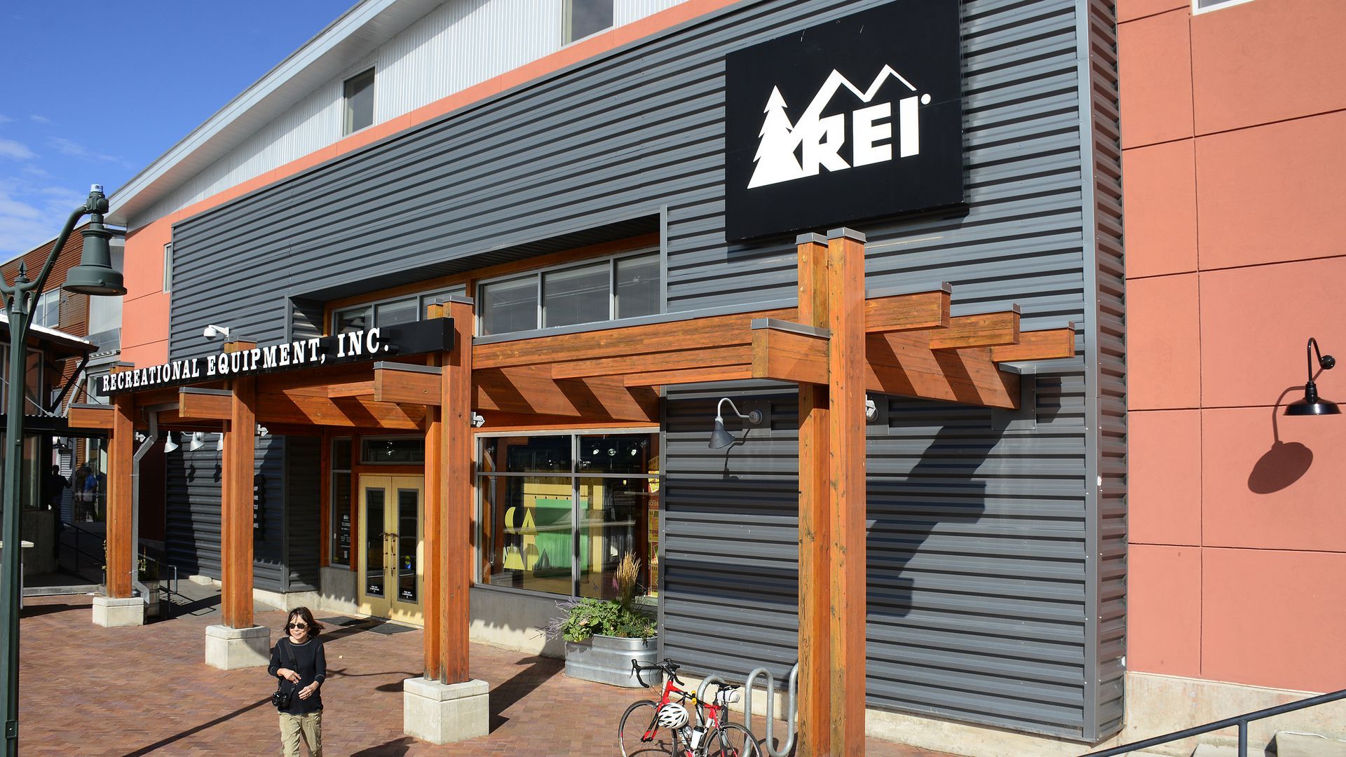 A picture of a customer leaving a Recreational Equipment store.