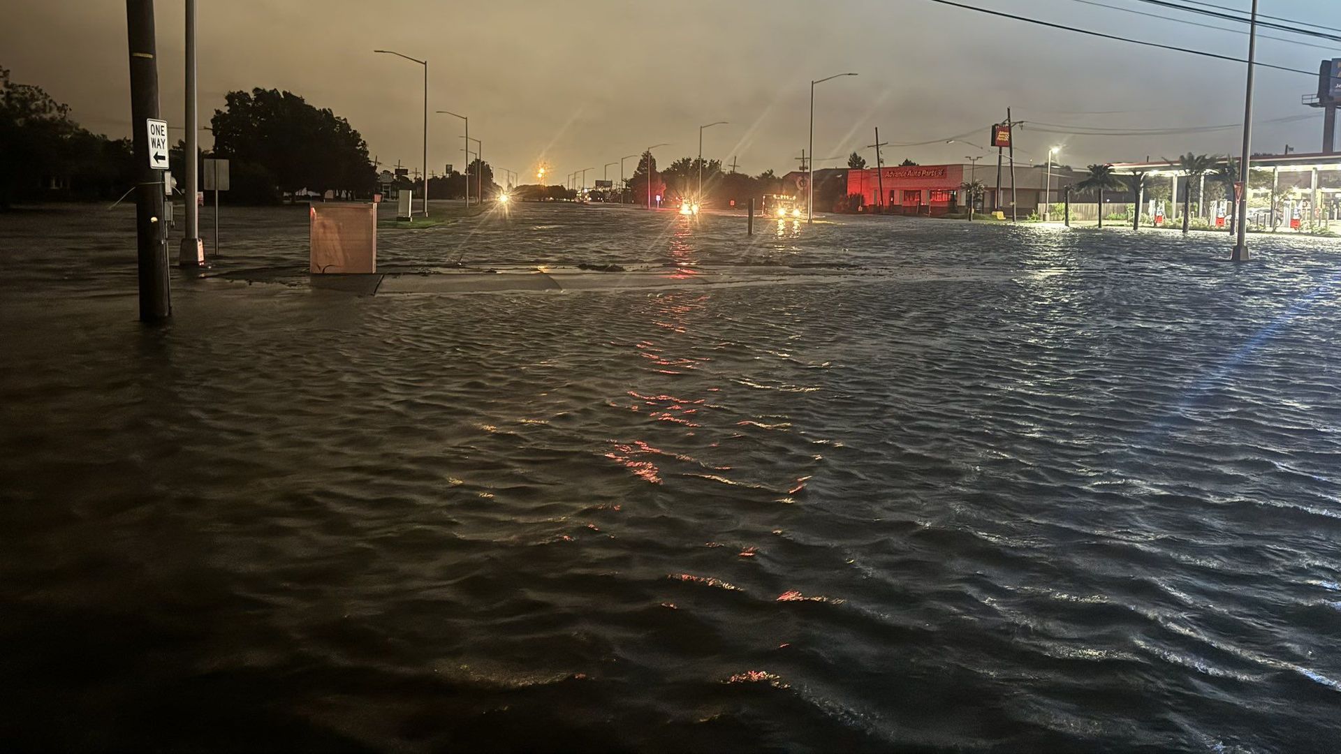 Image shows a flooded road in Metairie.