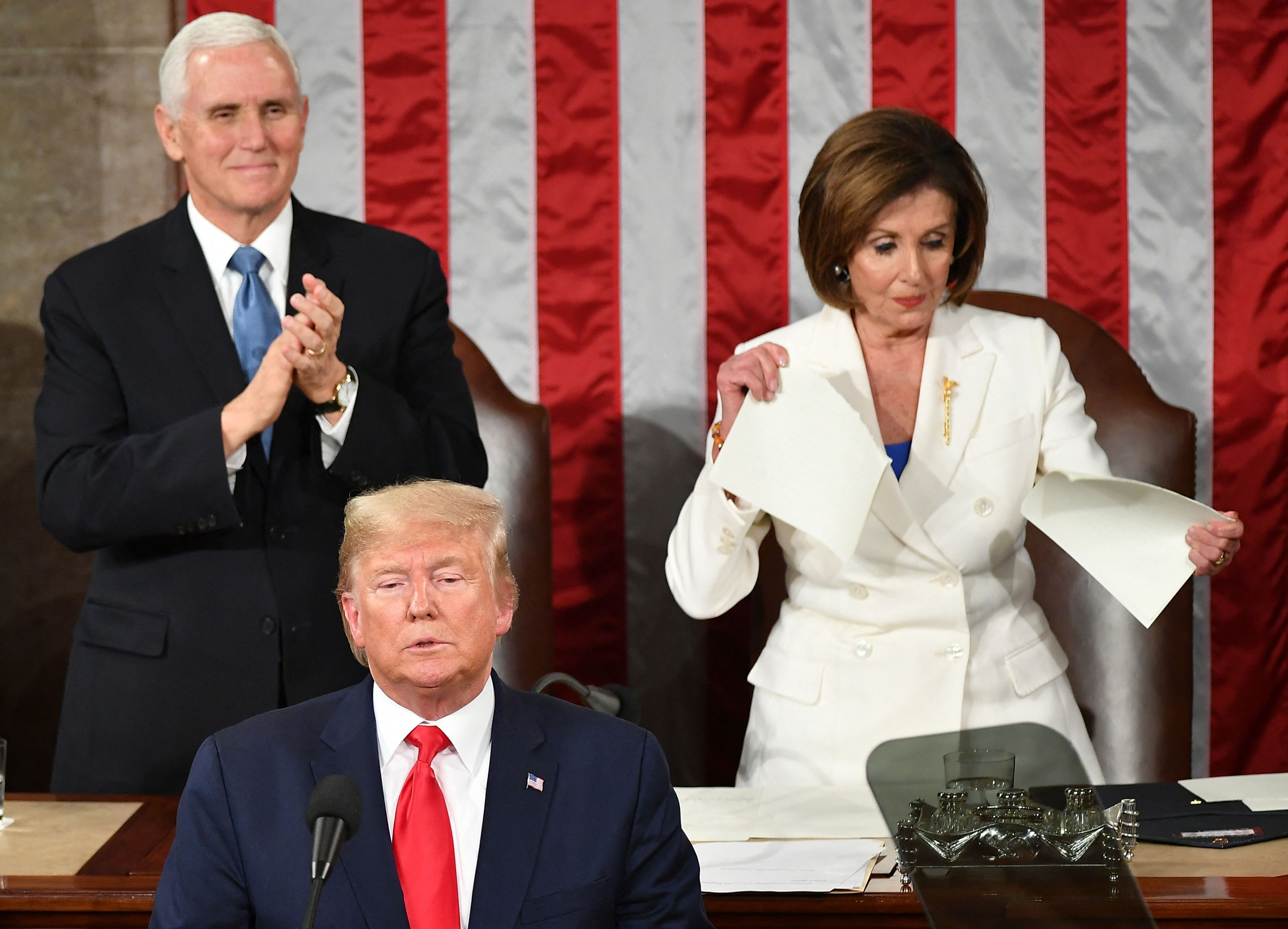 Nancy Pelosi rips up President Trump's speech behind the podium as Mike Pence claps during the 2020 State of the Union address.