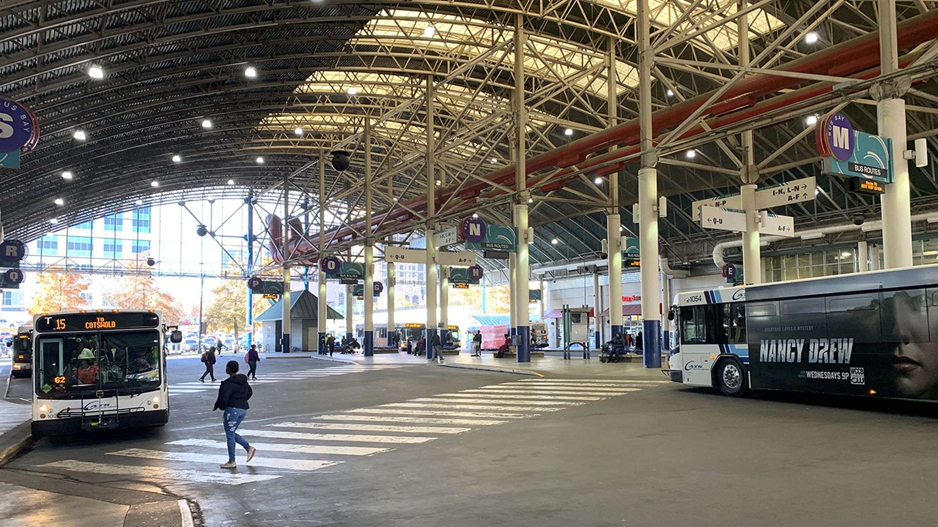 main transit center in Uptown Charlotte, with buses flowing through and people getting on