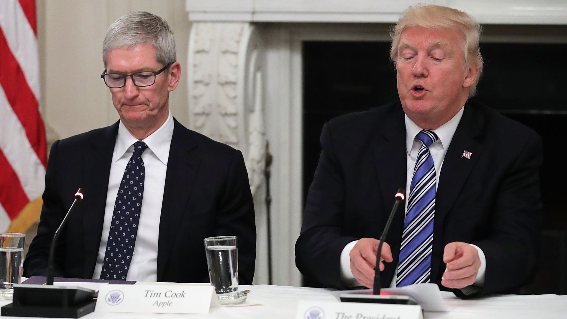 Photo of Apple CEO Tim Cook sitting next to President Trump at a 2017 White House meeting
