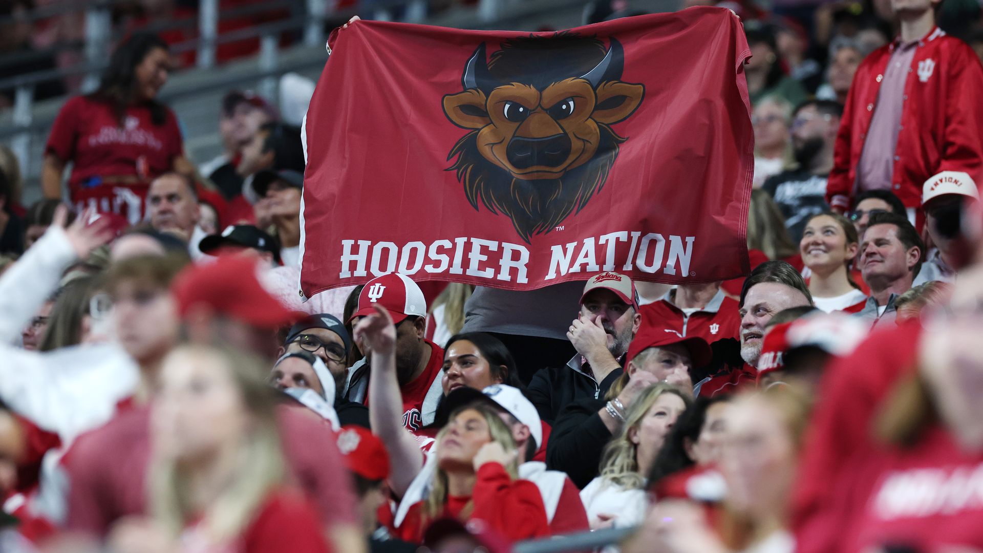 A Hoosier Nation flag waves in a crowd.