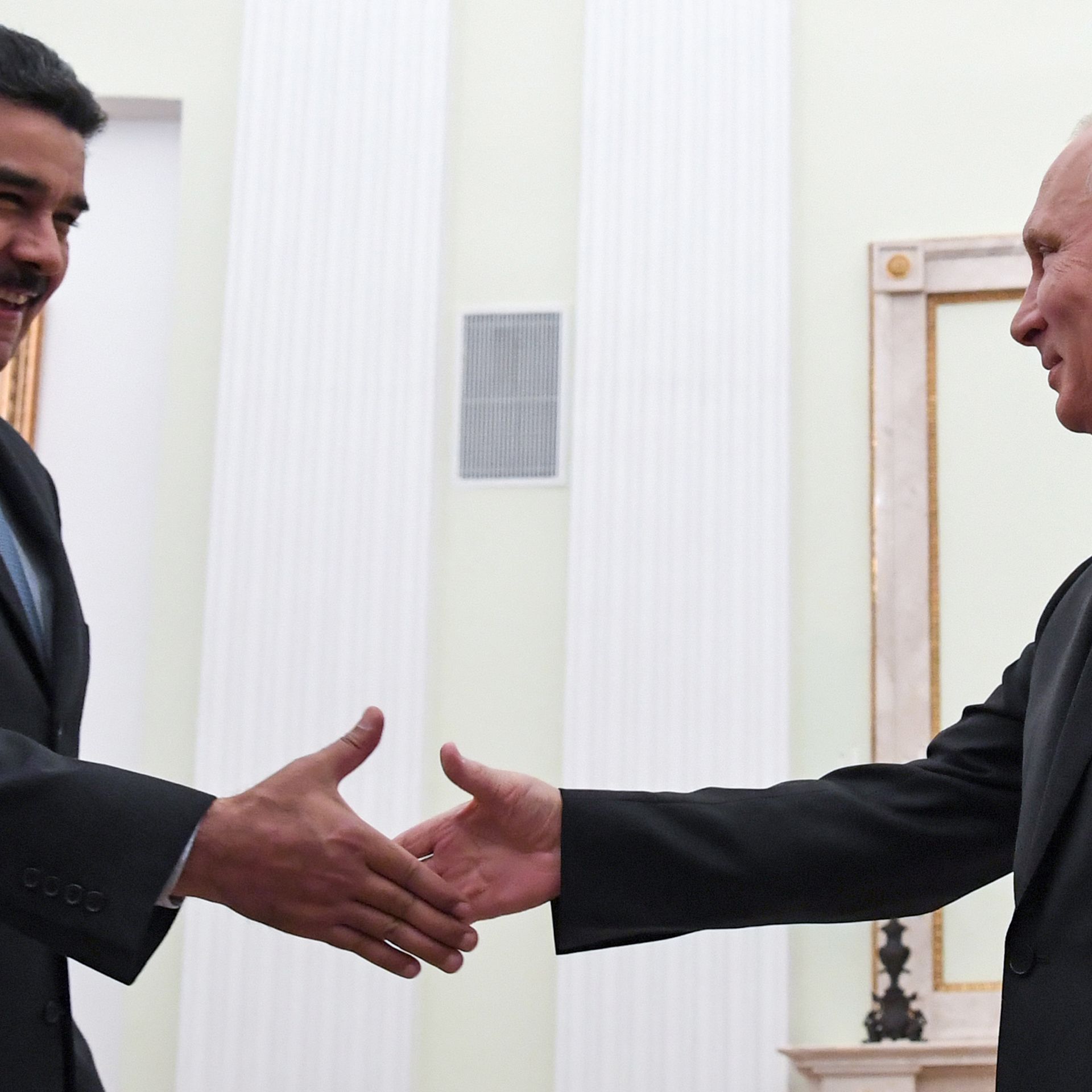 Russian President Vladimir Putin (R) shakes hands with his Venezuelan counterpart Nicolas Maduro during a meeting at the Kremlin in Moscow on October 4, 2017. 