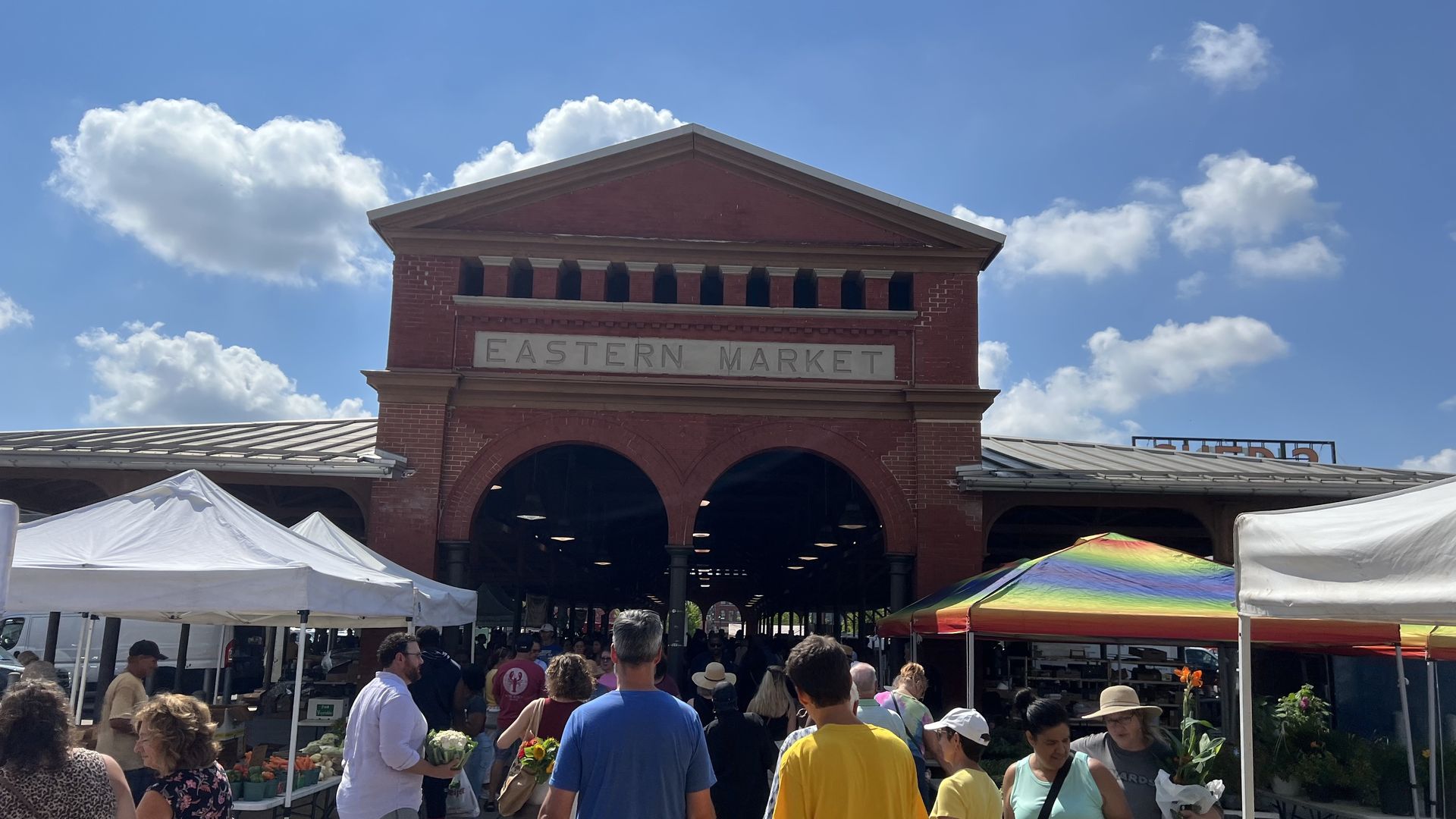 Eastern market shed with shoppers walking through the entrance.