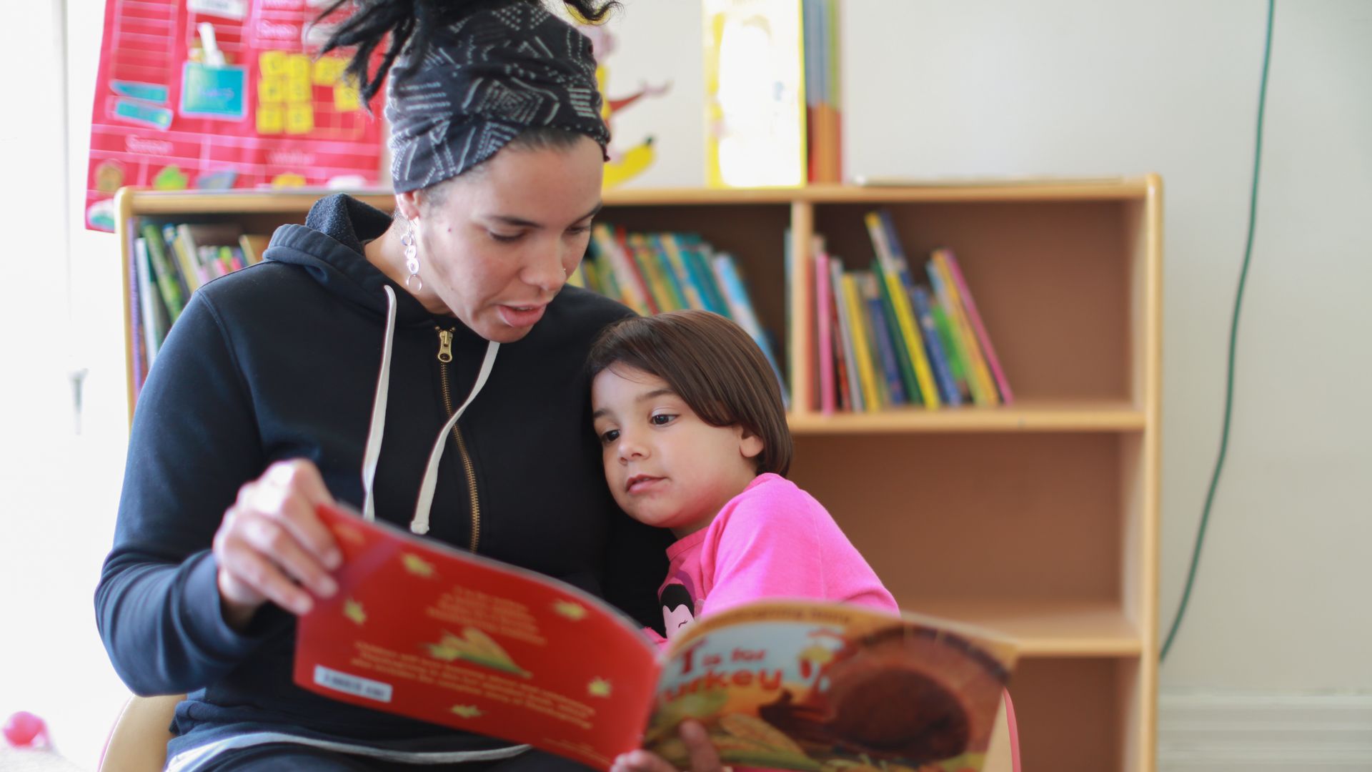 A volunteer reads to a child