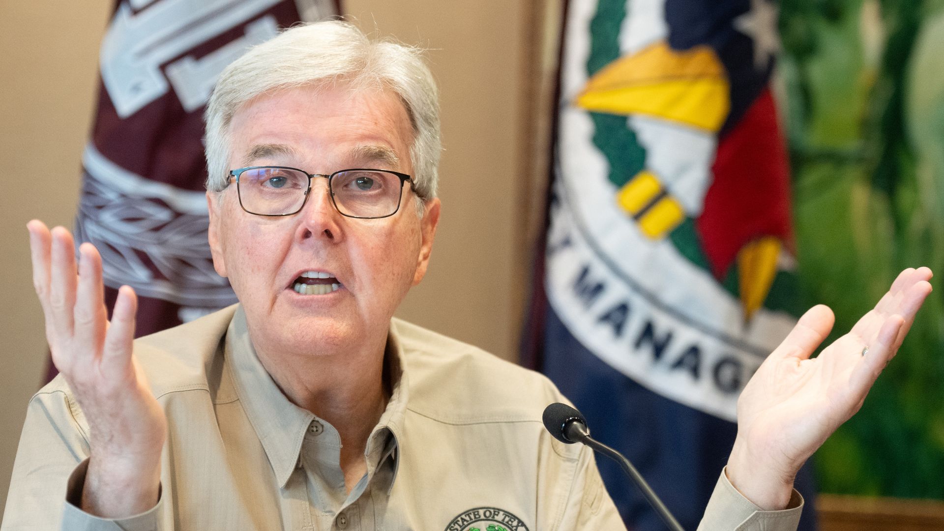 Texas Lt. Gov. Dan Patrick waves his hands as he speaks at a news conference