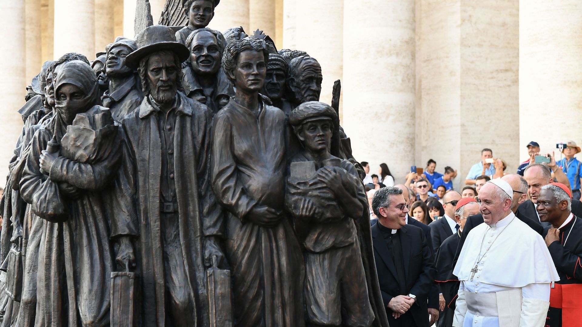 Pope Francis with a statue.