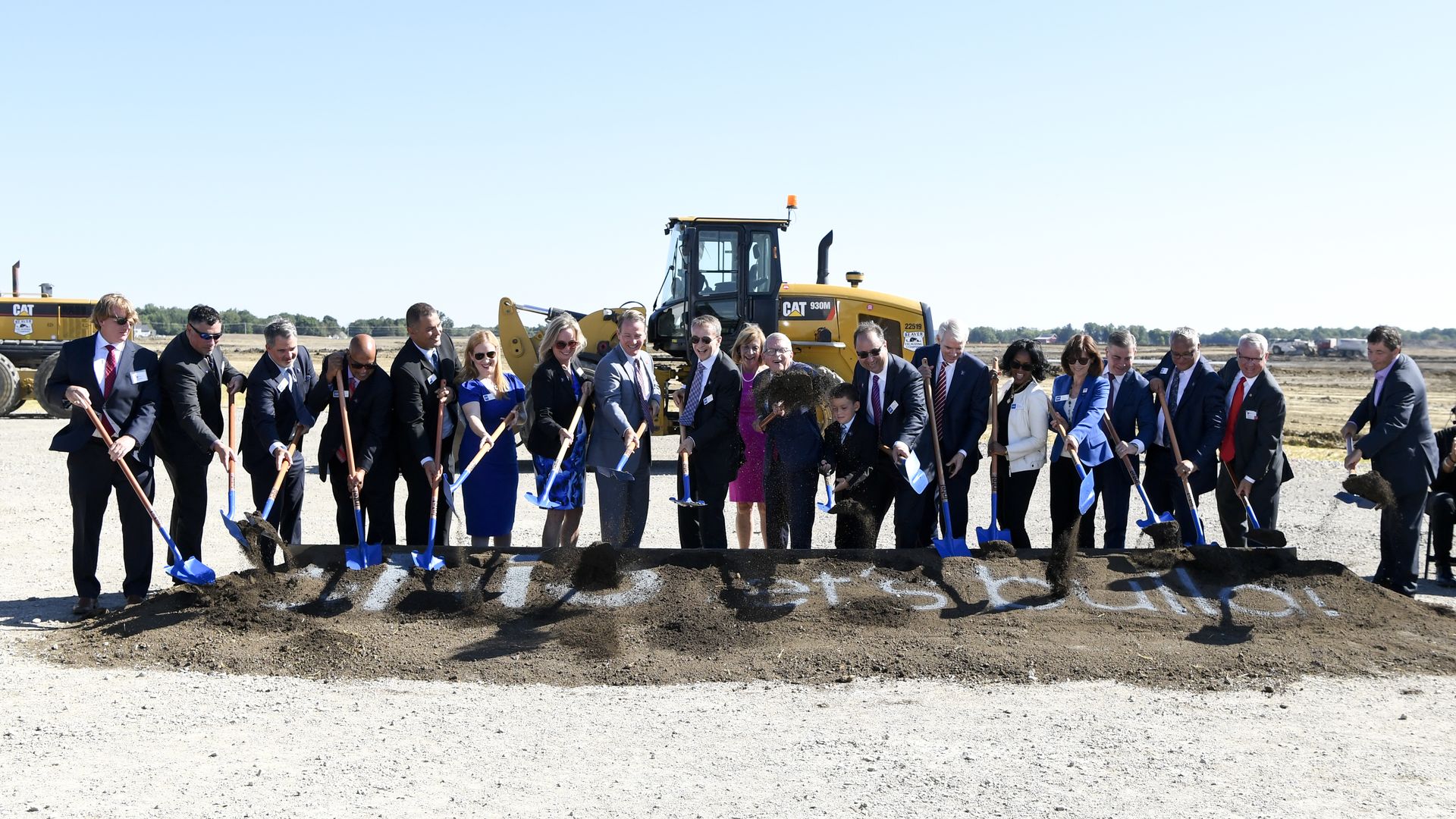 A groundbreaking at Intel's Ohio One project staged in front of construction equipment