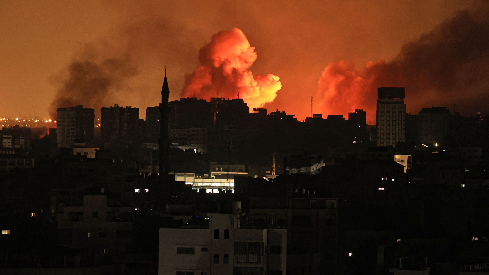 A ball of fire erupts in Gaza City after an Israeli air strike on October 12, 2023. 