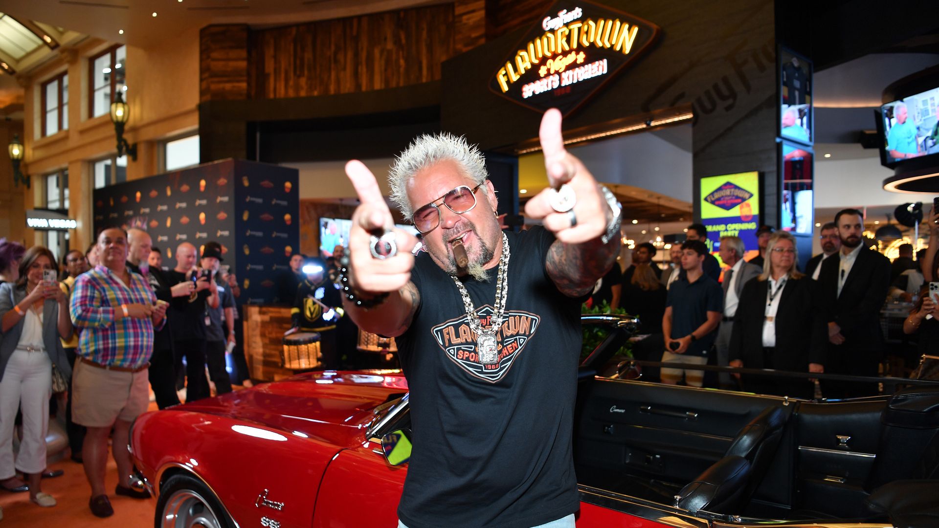Guy Fieri poses with his Chevrolet Camaro