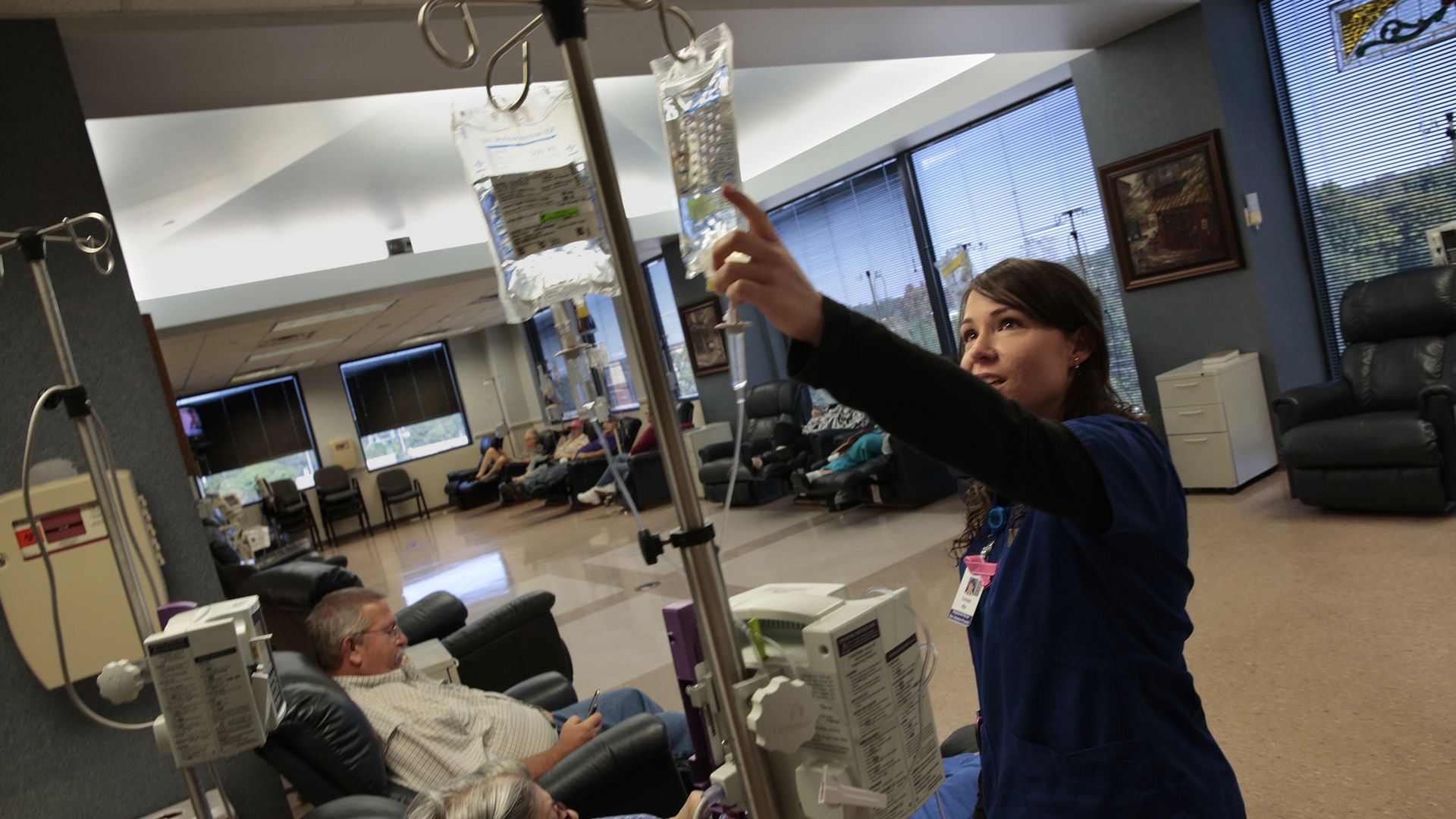A nurse works in a hospital's oncology infusion center.