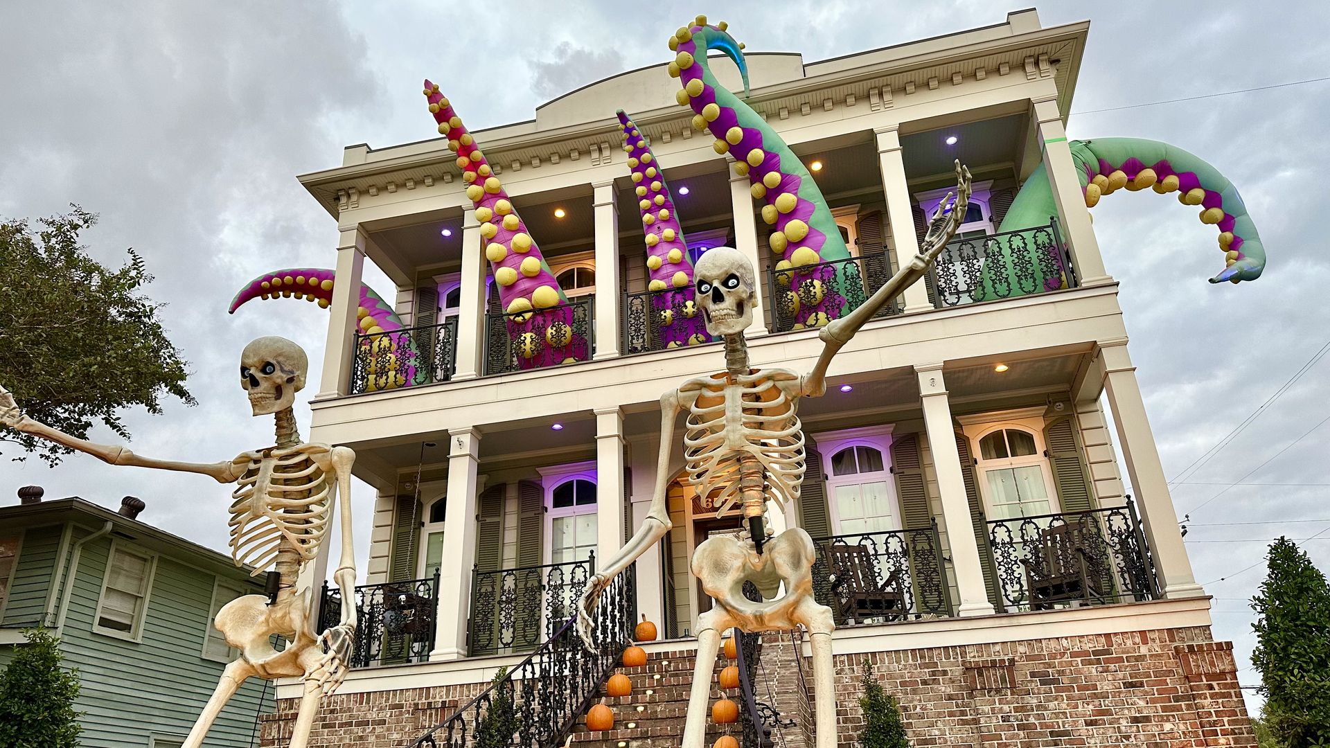 Photo shows giant skeletons in front of a house with tentacles.