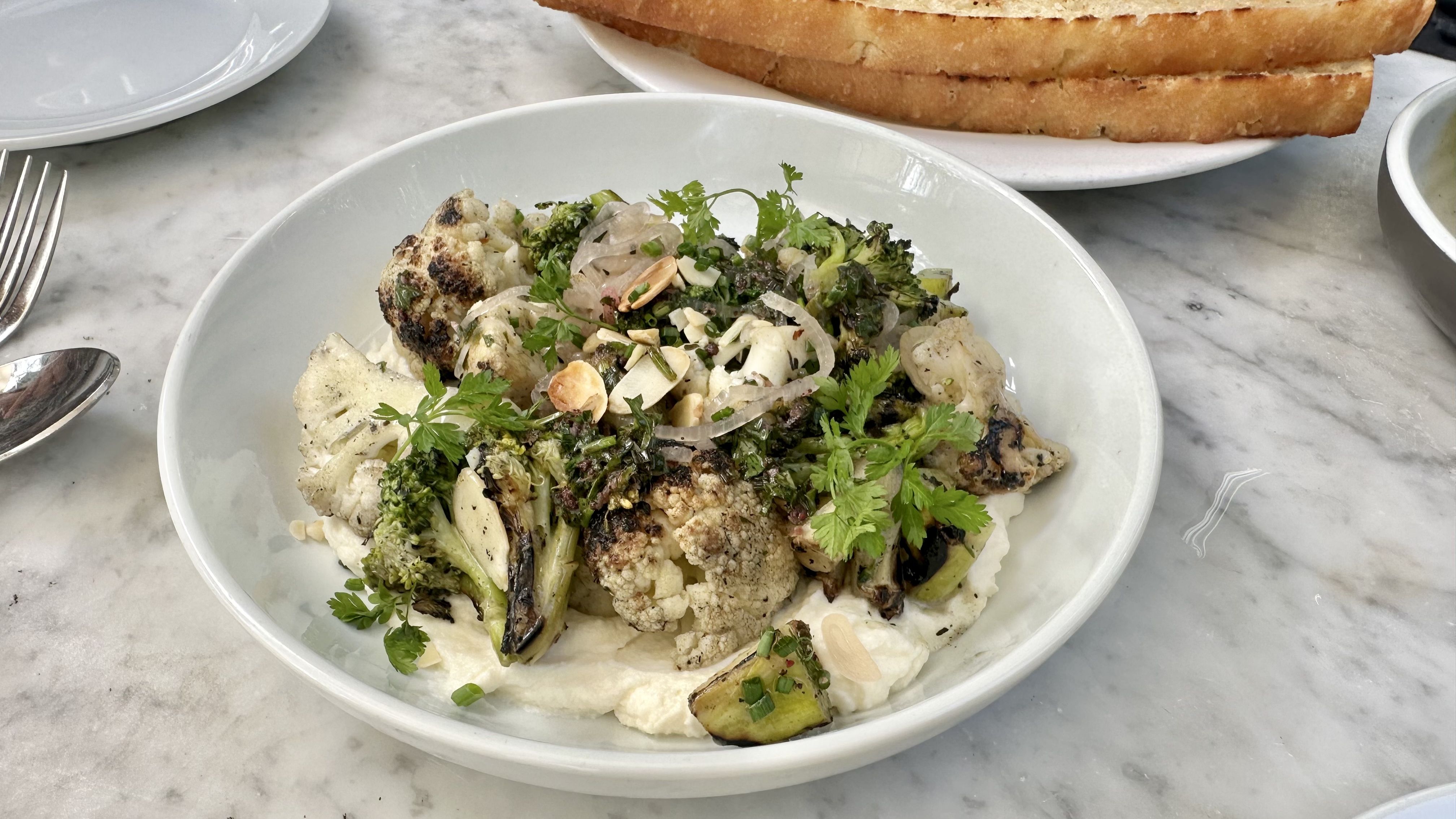 Photo shows a charred broccoli and cauliflower salad.