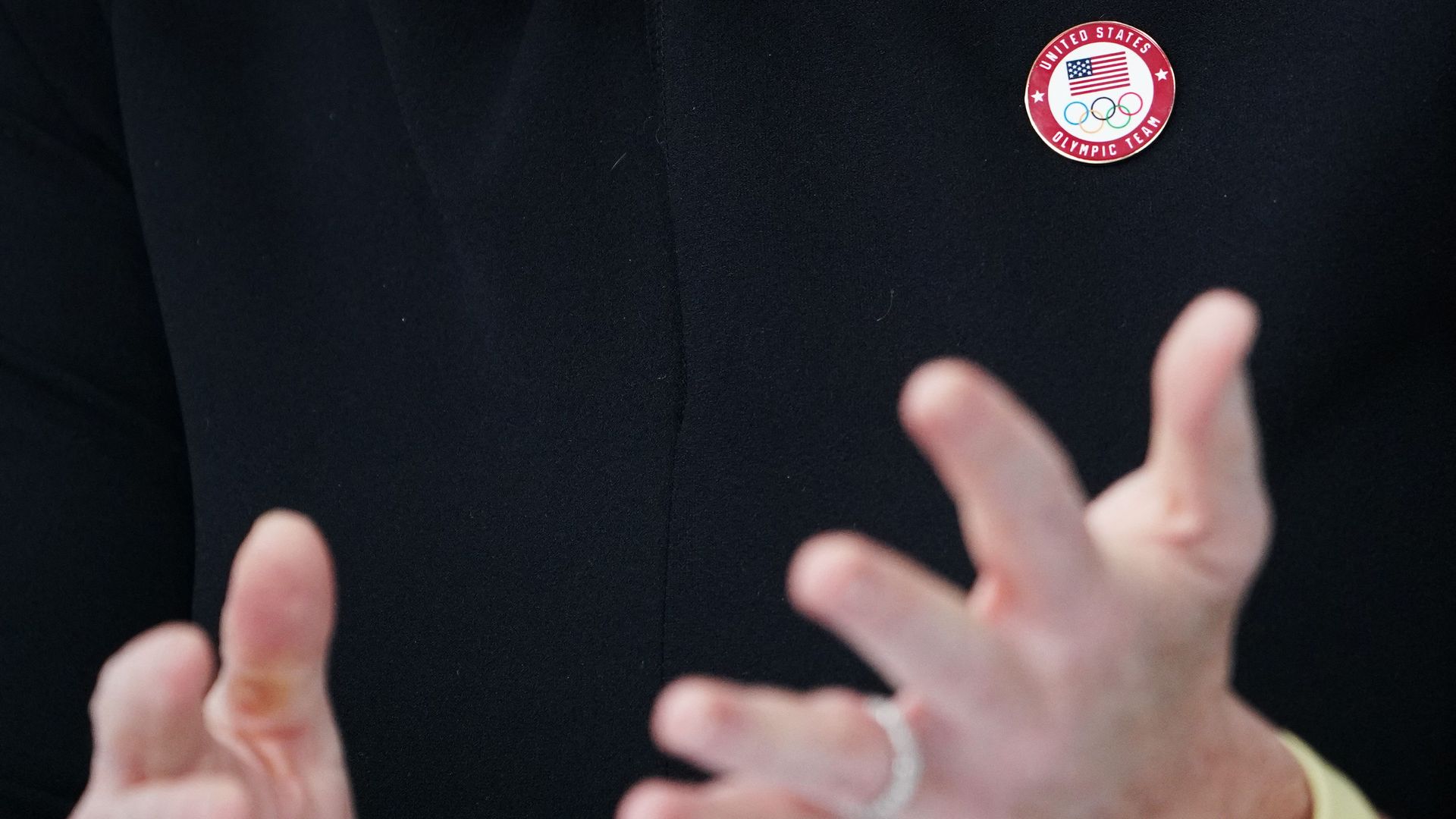 A U.S. Olympic team pin is seen being worn by White House press secretary Jen Psaki.