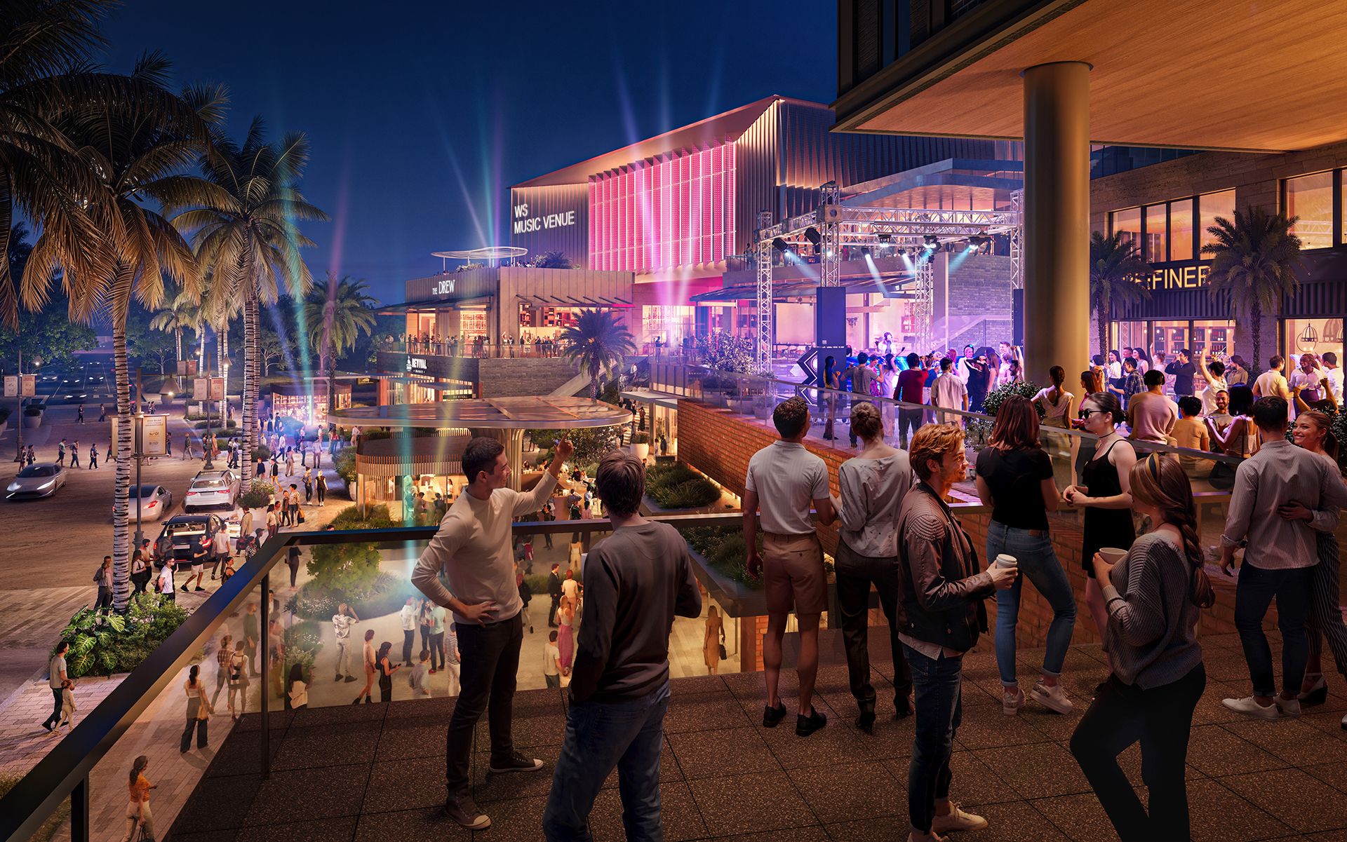 Night scene of a lively outdoor music venue with crowds socializing under palm trees and colorful lights, with a modern building labeled WS Music Venue and The Drew illuminated in pink and blue.