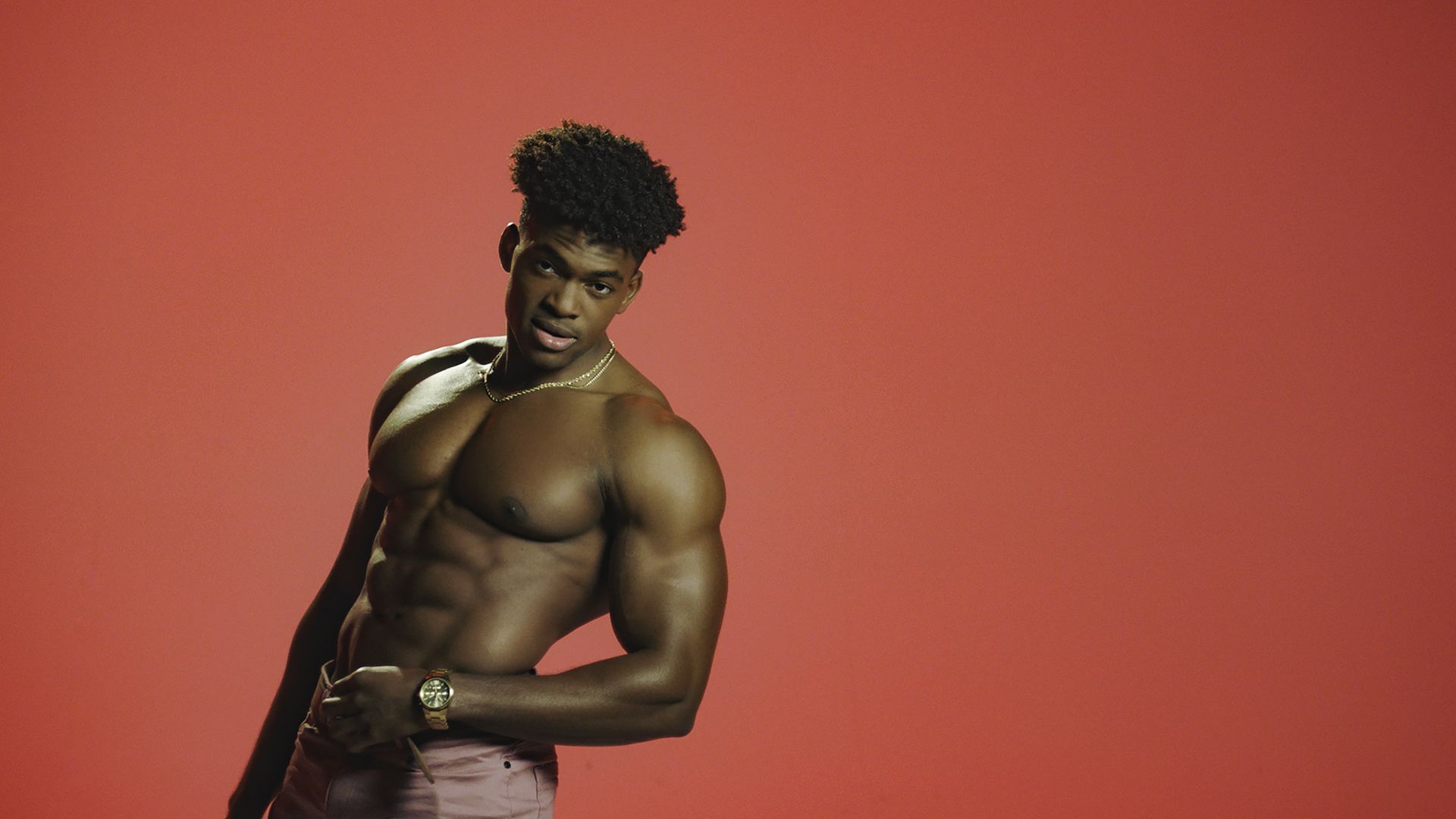 The Circle contestant Marvin Achi poses shirtless for a promotional photo