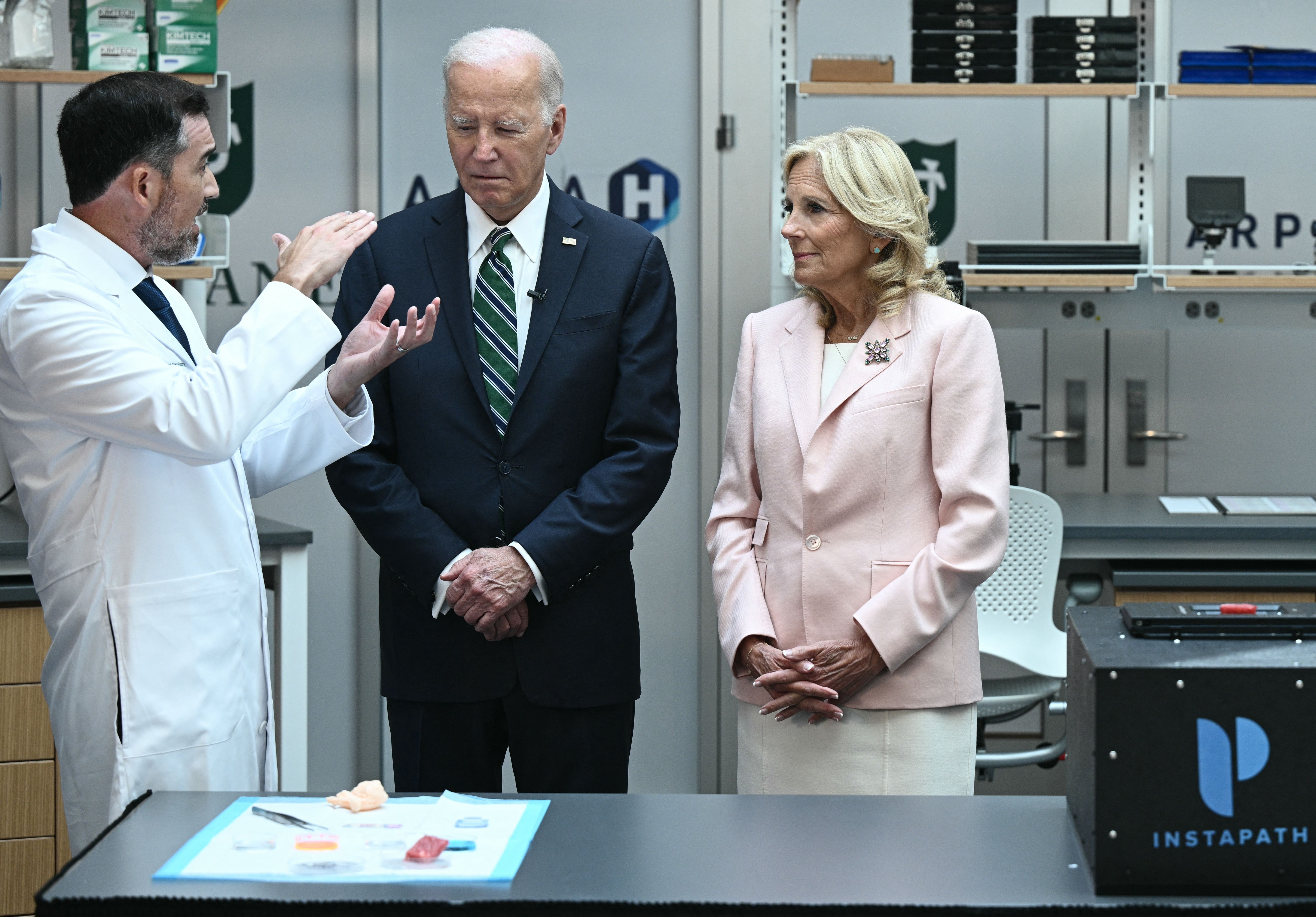 Photo shows cancer researcher Quincy Brown, President Joe Biden and first lady Jill Biden.