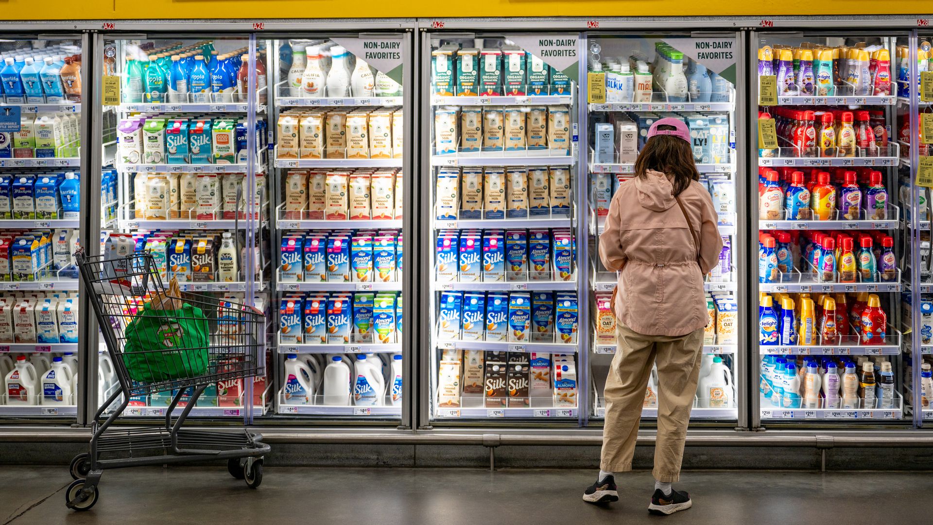 A person looks at milk inside an HEB