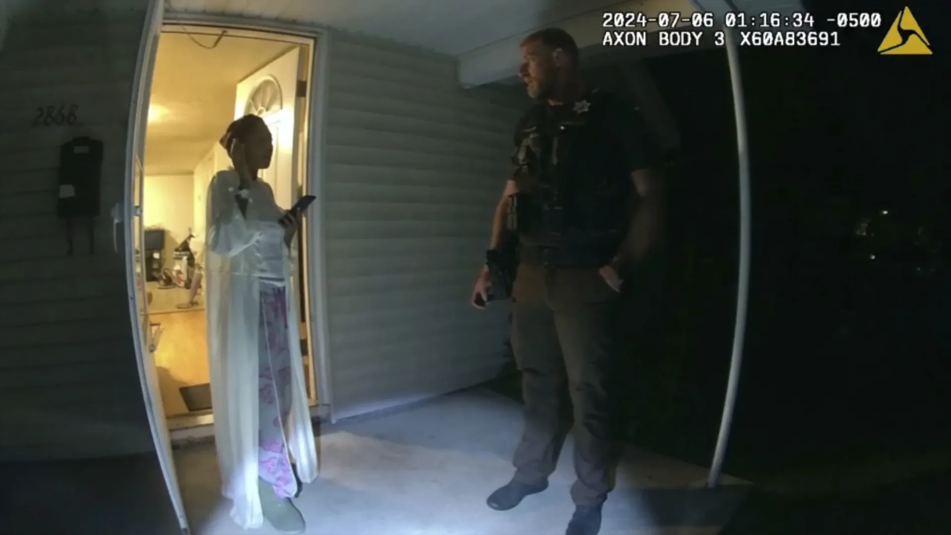 Sonya Massey, left, talks with former Sangamon County Sheriff's Deputy Sean Grayson outside her home in Springfield, III., July 6, 2024 in footage released by Illinois State Police.