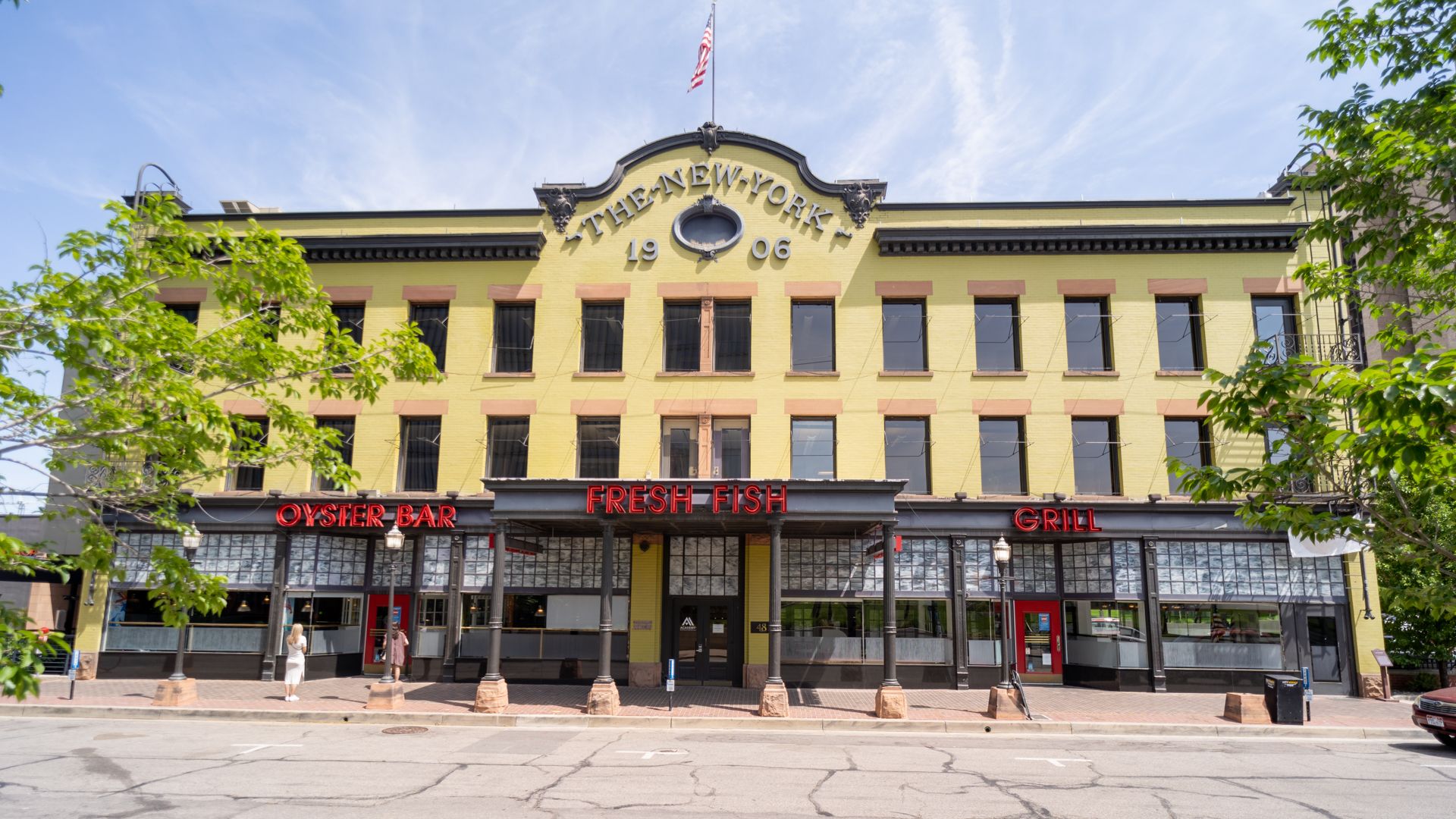 An early-1900s building with a yellow brick facade and a seafood restaurant inside
