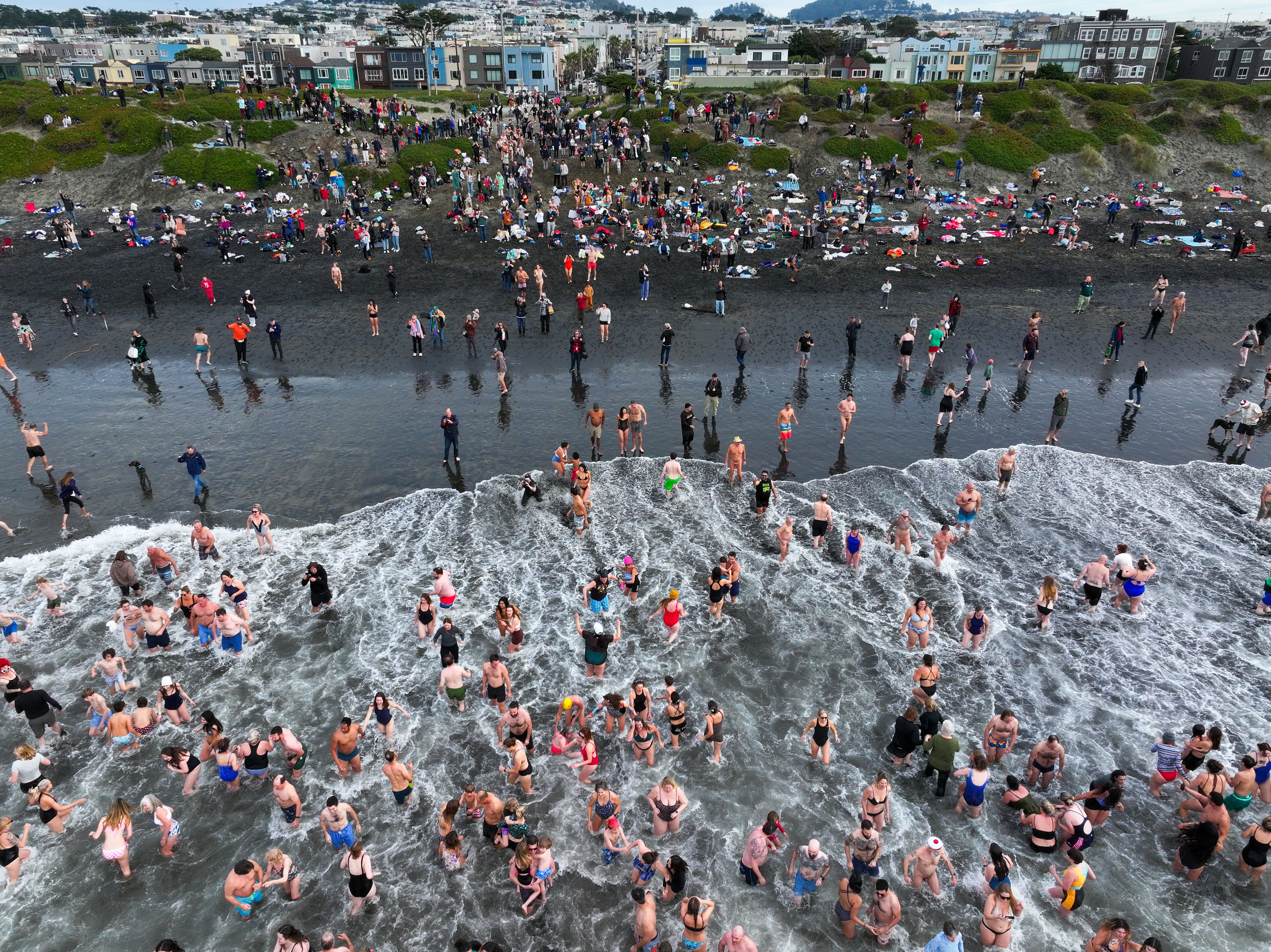 : Hundreds of San Franciscans are gathered at Ocean Beach for a Polar Plunge into Pacific Ocean's cold water in San Francisco, California, United States on January 1, 2025. Plunging in cold water, known affectionately as polar bear swims, has been around for decades. The first documented New Year's