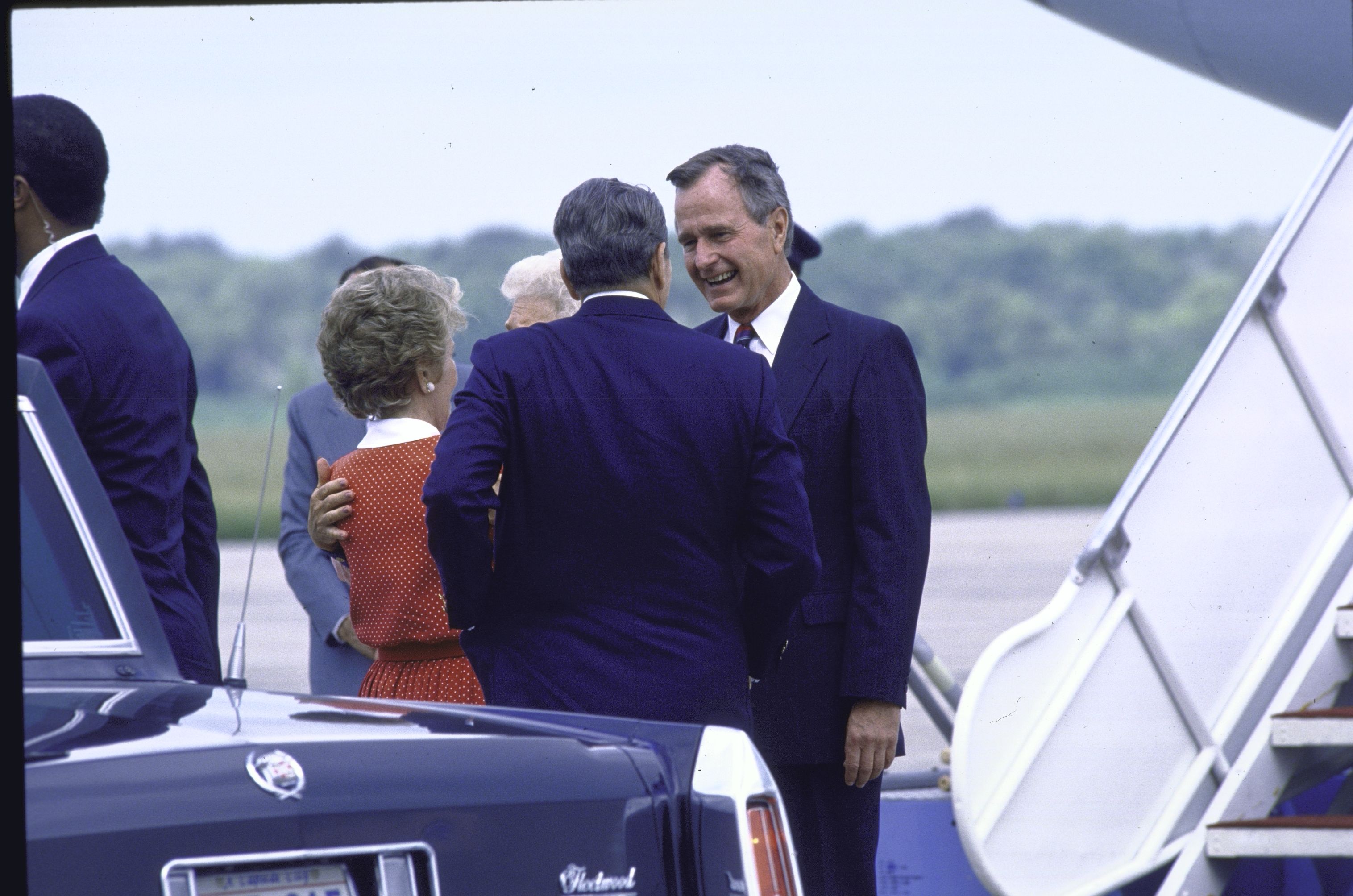 Photo shows US Vice President George H. with Bush welcoming President Ronald and his wife to Belle Chase Naval Air Base. 
