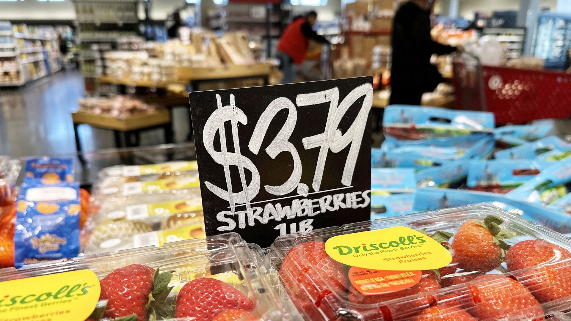 A photo of strawberries under a $3.79 price sign 