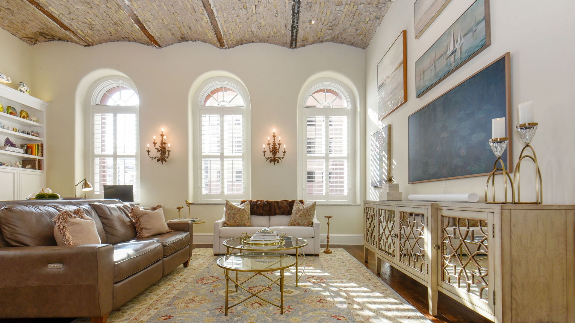 A photo of a white apartment with curved ceilings and arches windows.