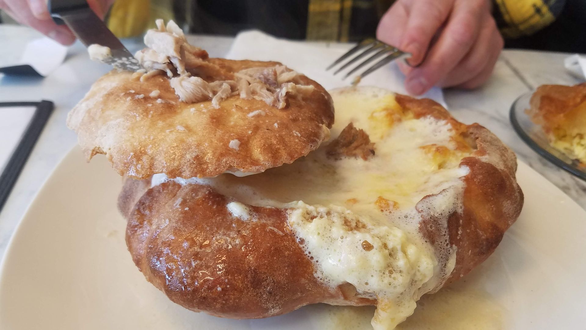 Photo of a cheesy pastry on a table 