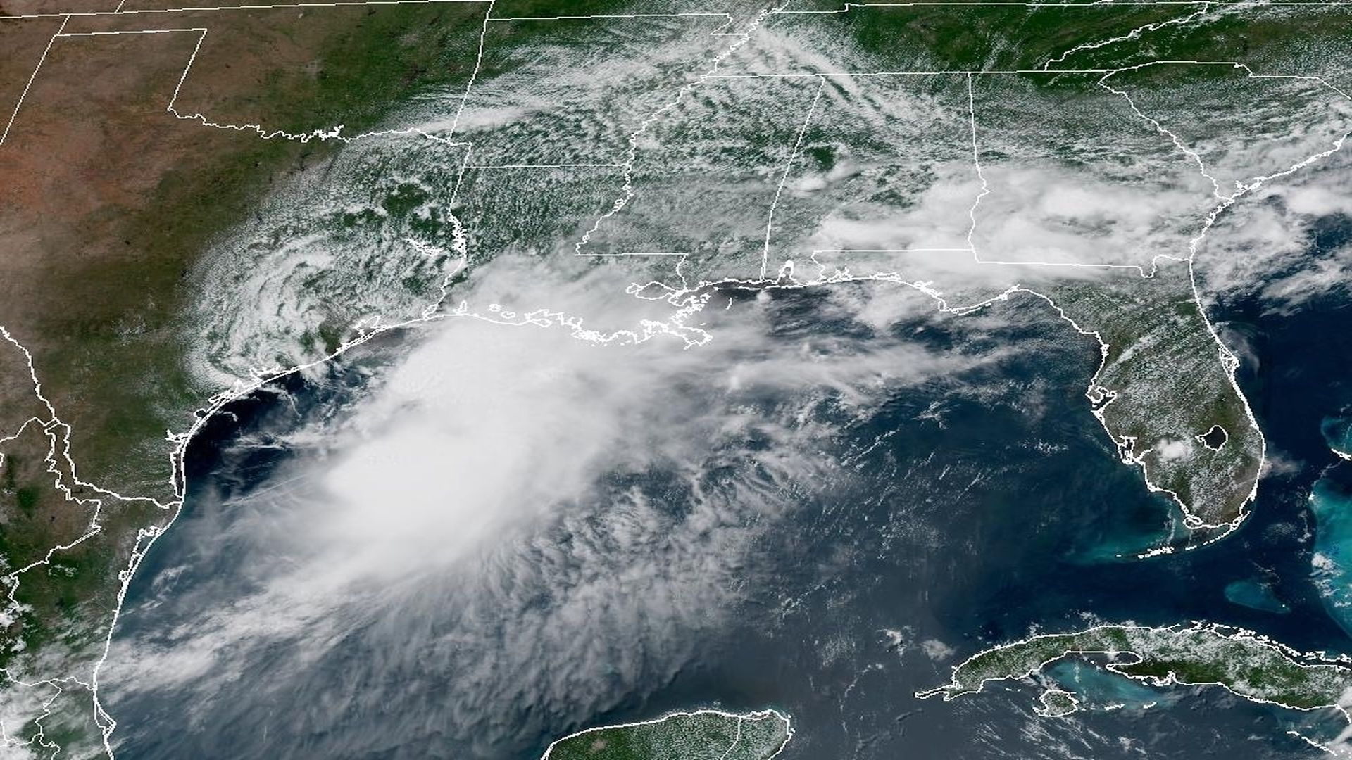 GOES-19 satellite image of the Gulf of Mexico showing a large cloud mass over the northwestern Gulf, Florida to the east, Cuba to the south, and the surrounding U.S. coast; NOAA logo bottom left.