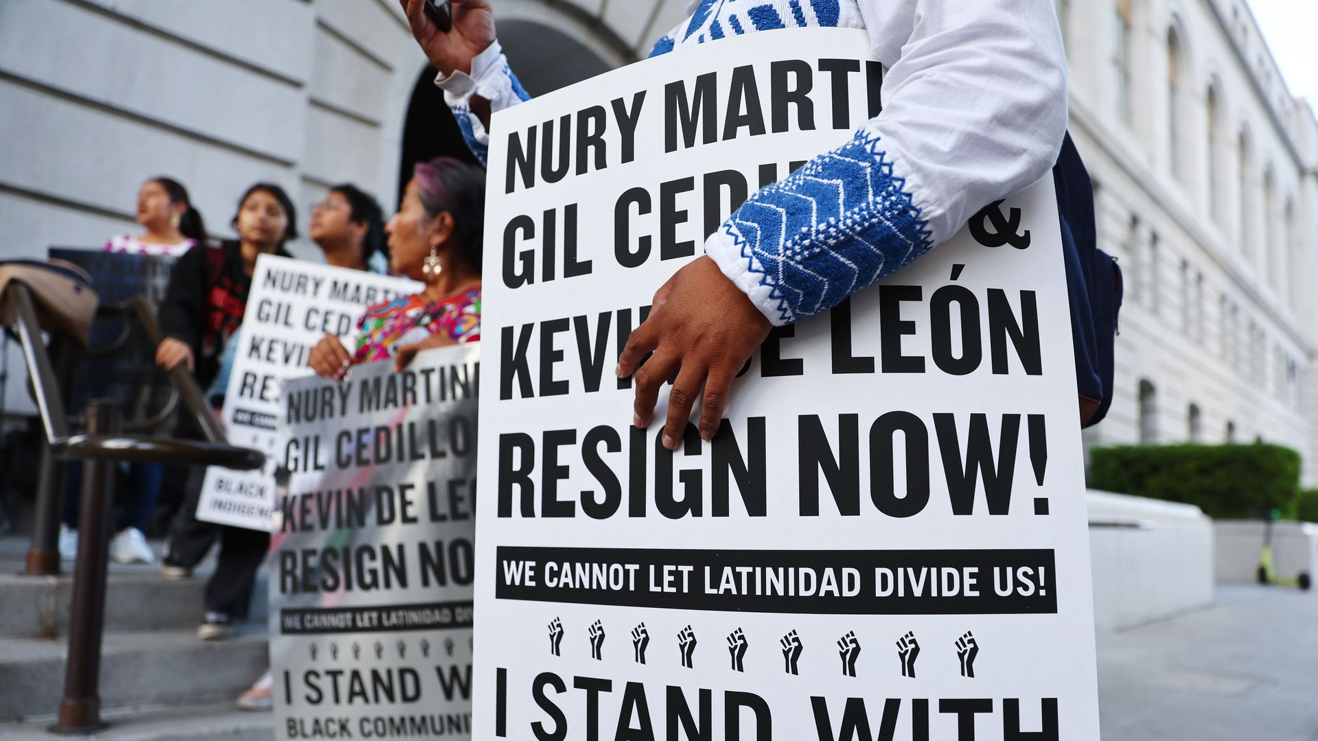 Photo of protesters holding signs calling on Nury Martinez to resign