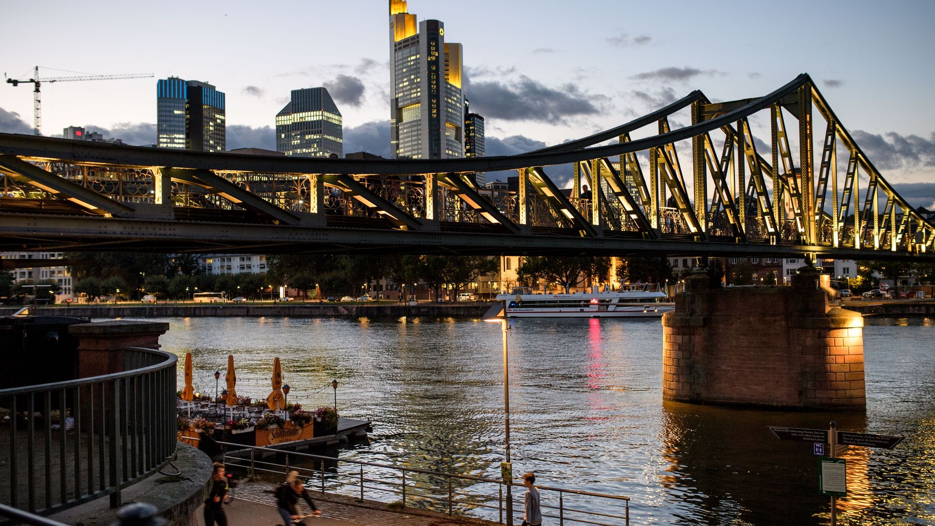 The Frankfurt skyline with a bridge over a river and skyscrapers in the back