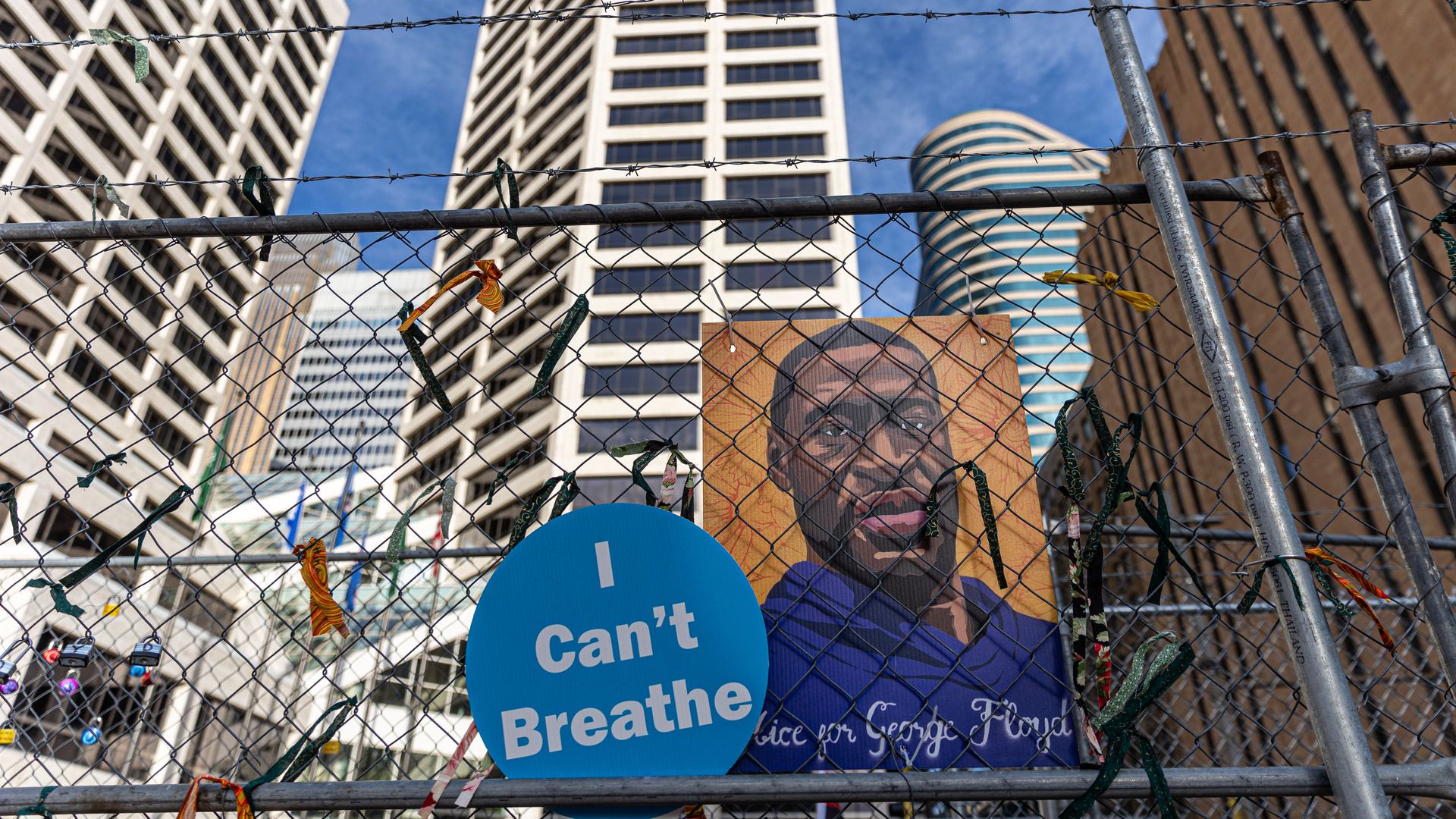 A poster with George Floyd's picture and a sign reads that "I can't Breathe" hang from a security fence outside the Hennepin County Government Center on March 30, 2021 in Minneapolis, Minnesota.