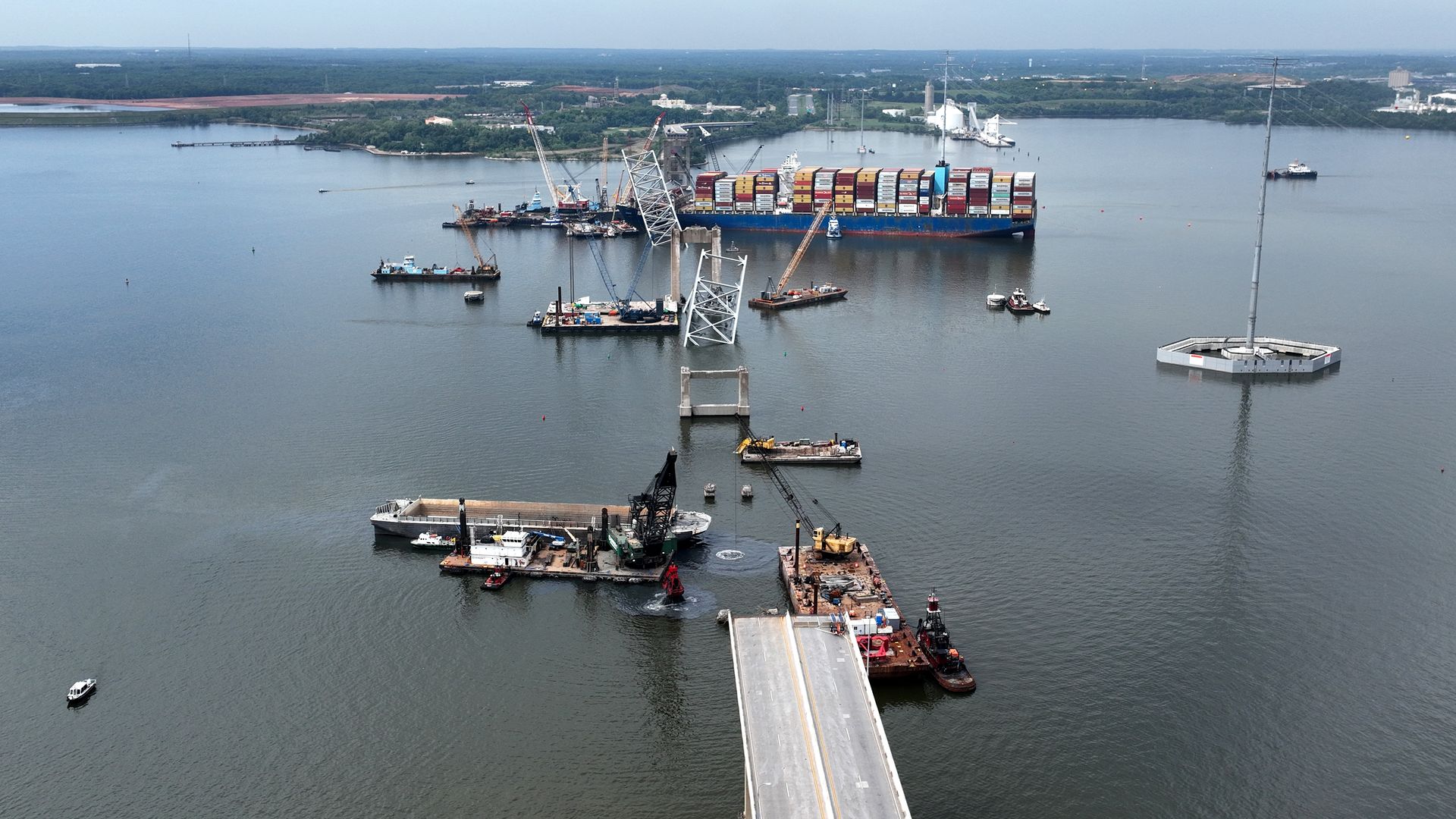 In this aerial view, salvage crews continue to remove wreckage from the Dali six weeks after the cargo ship collided with the Francis Scott Key Bridge May 8, 2024, in Baltimore, Md. 