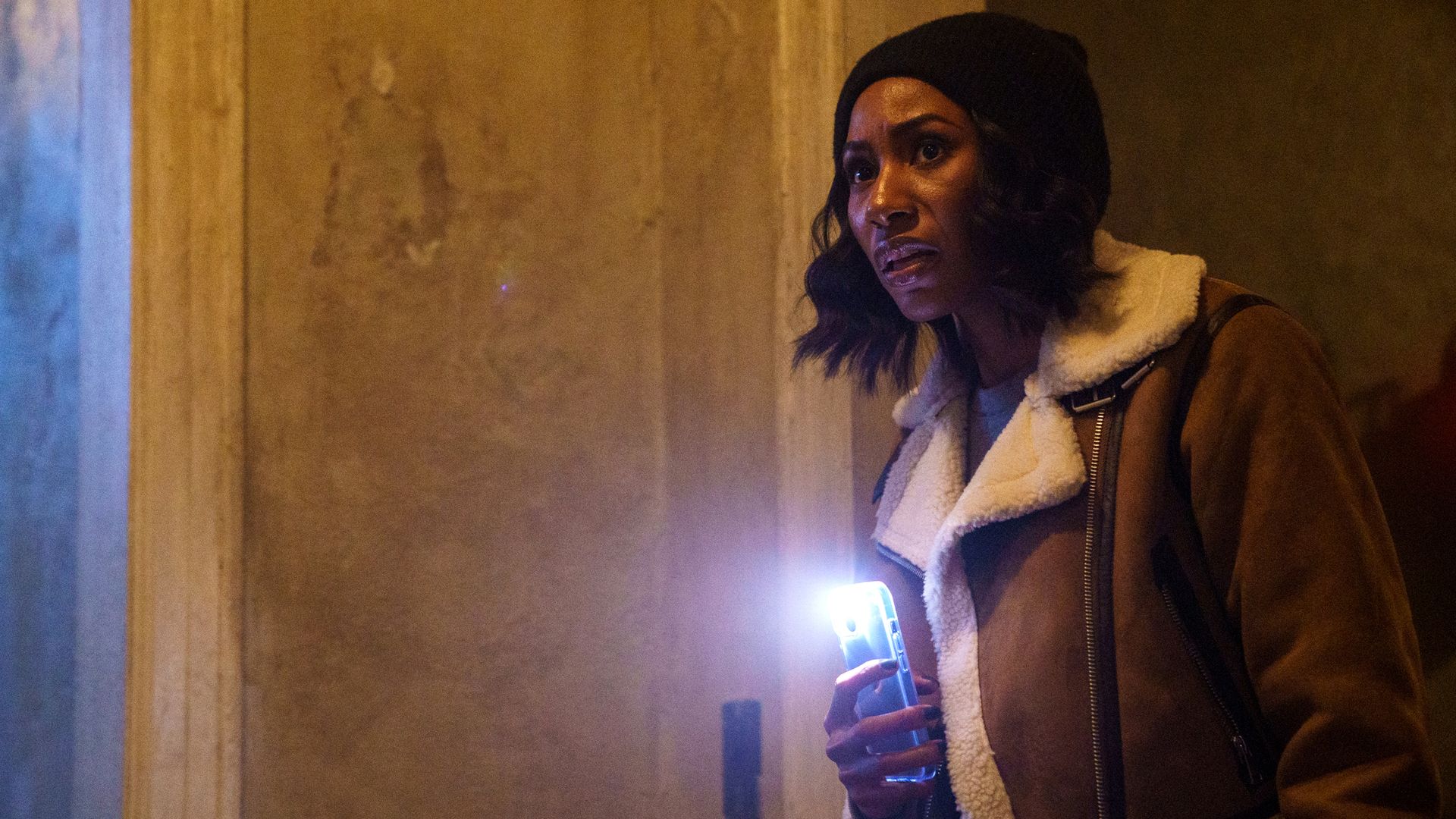 Diarra from Detroit screenshot, peering into the distance with a phone flashlight.