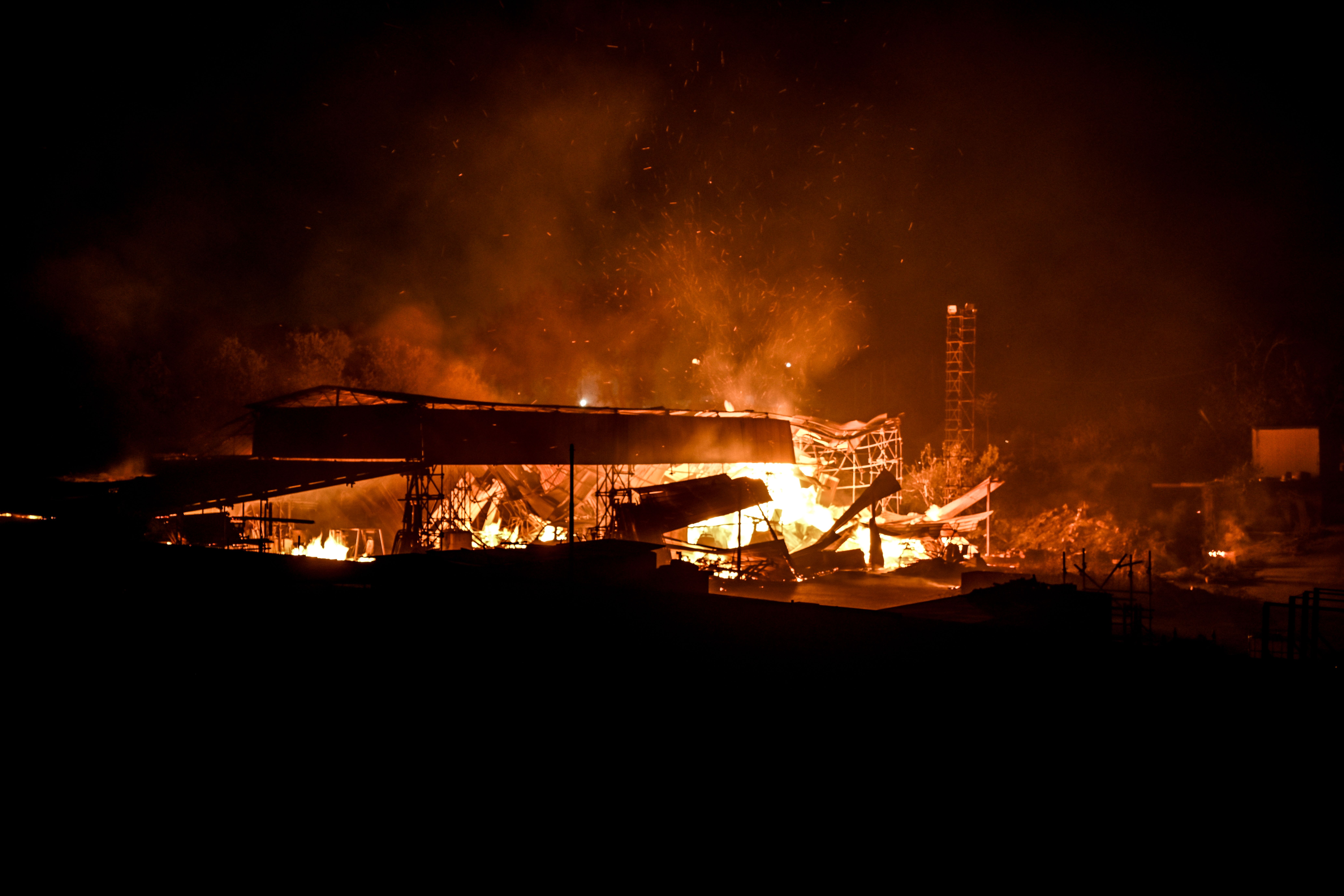 An abandoned shed engulfed in flames is one of several fires that spread this evening, fuelled by strong winds in the province of Catania on July 25, 2023 in Catania, Italy. Italy is experiencing a severe heatwave, with 16 cities on red alert, including Palermo and Catania on the island of Sicily where temperatures reached 47C and authorities reported some 40 wildfires in the region.