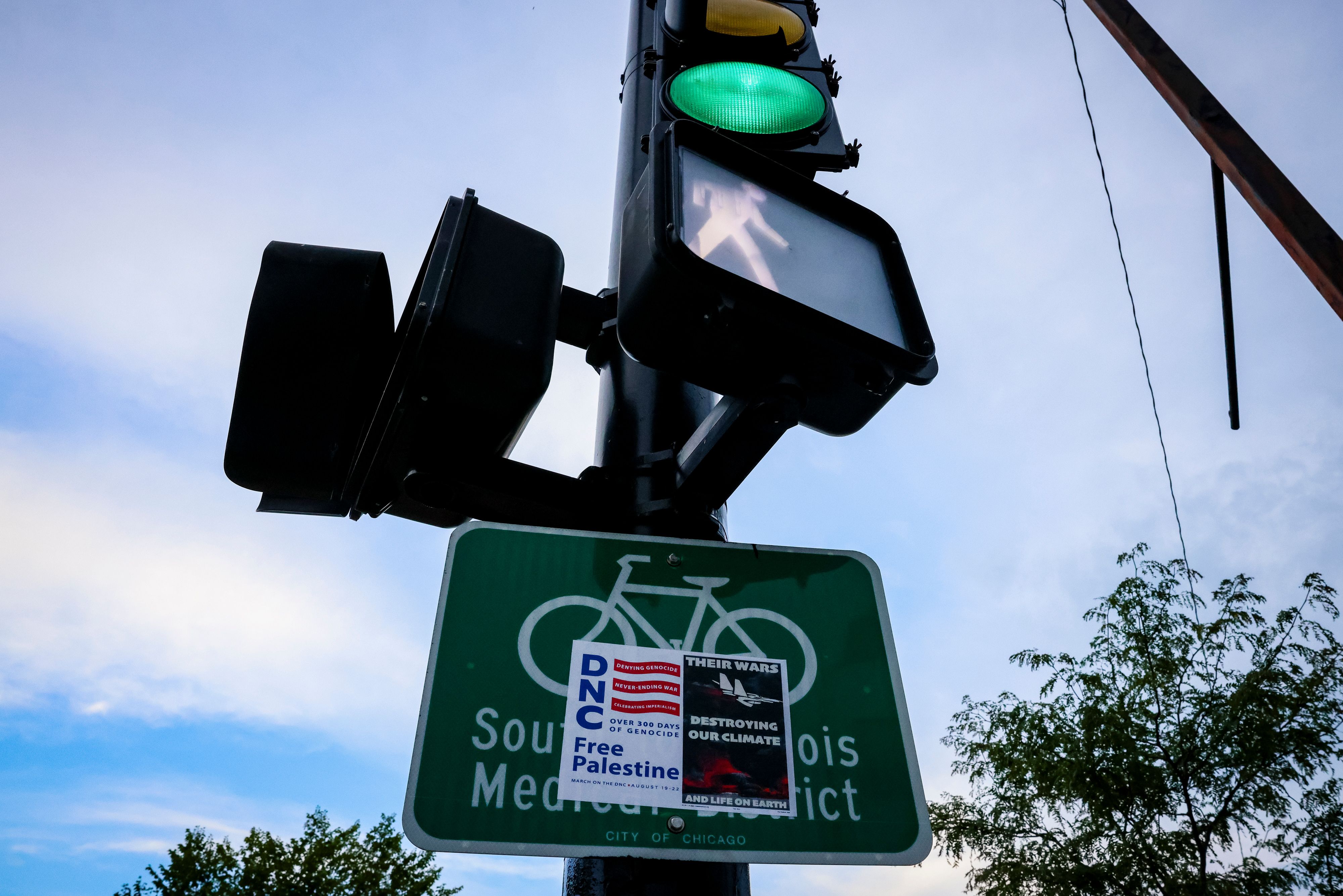 A sign for a protest on a traffic light